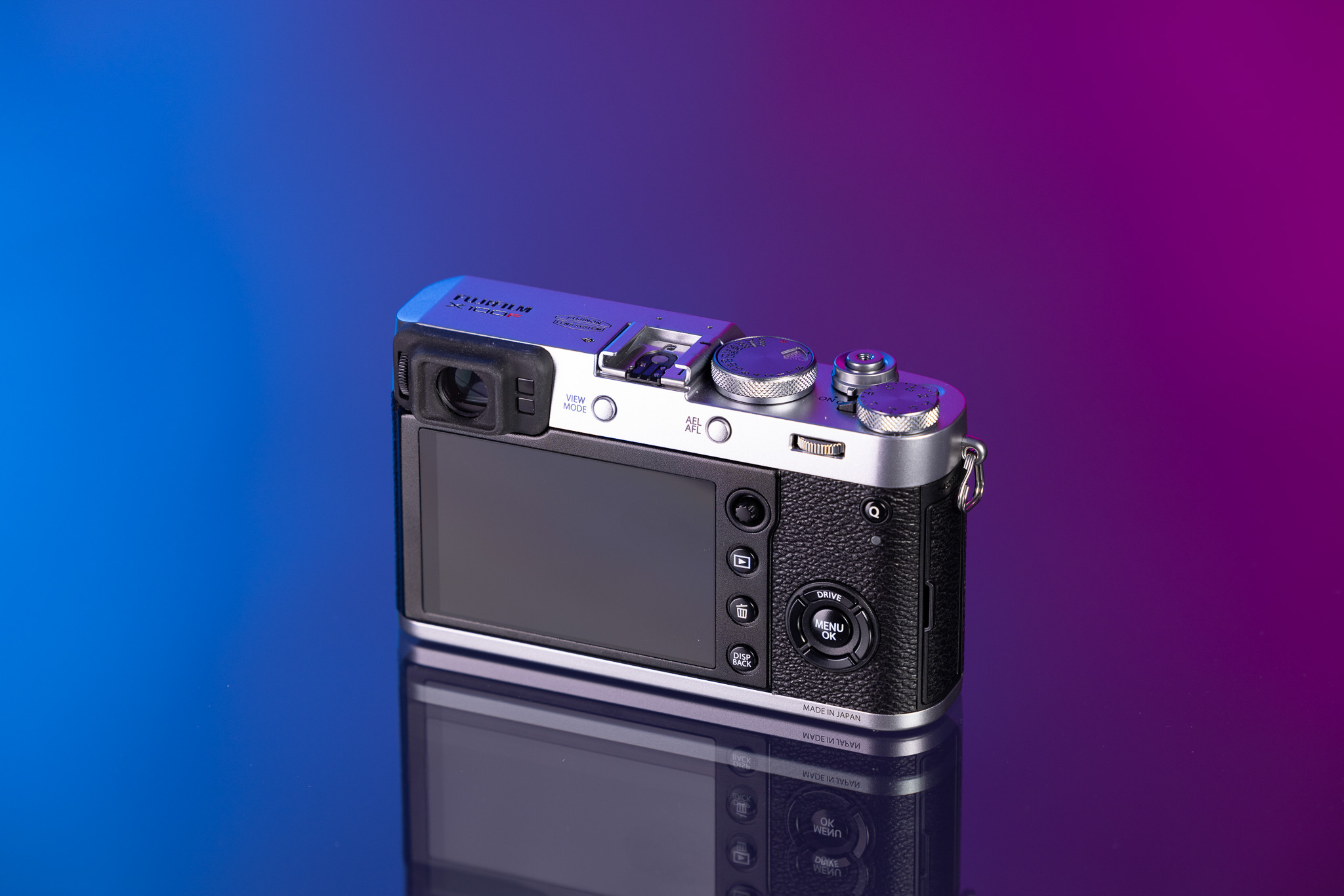 Silver Fujifilm X100F rear screen on a blue and purple background