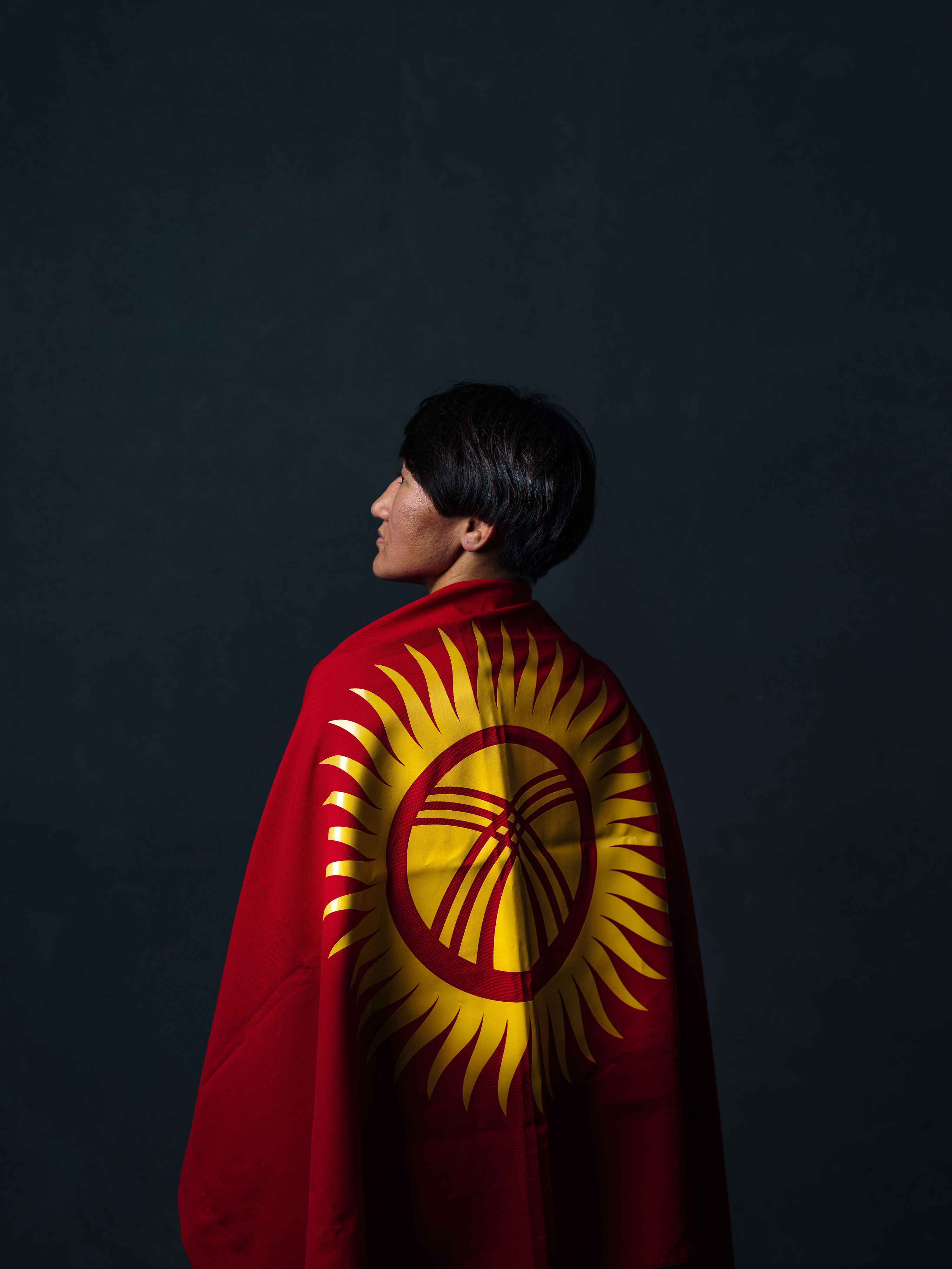 A portrait of a wrestler with a red cape from behind, shot on Phase One P45 Plus by Theo Lowenstein