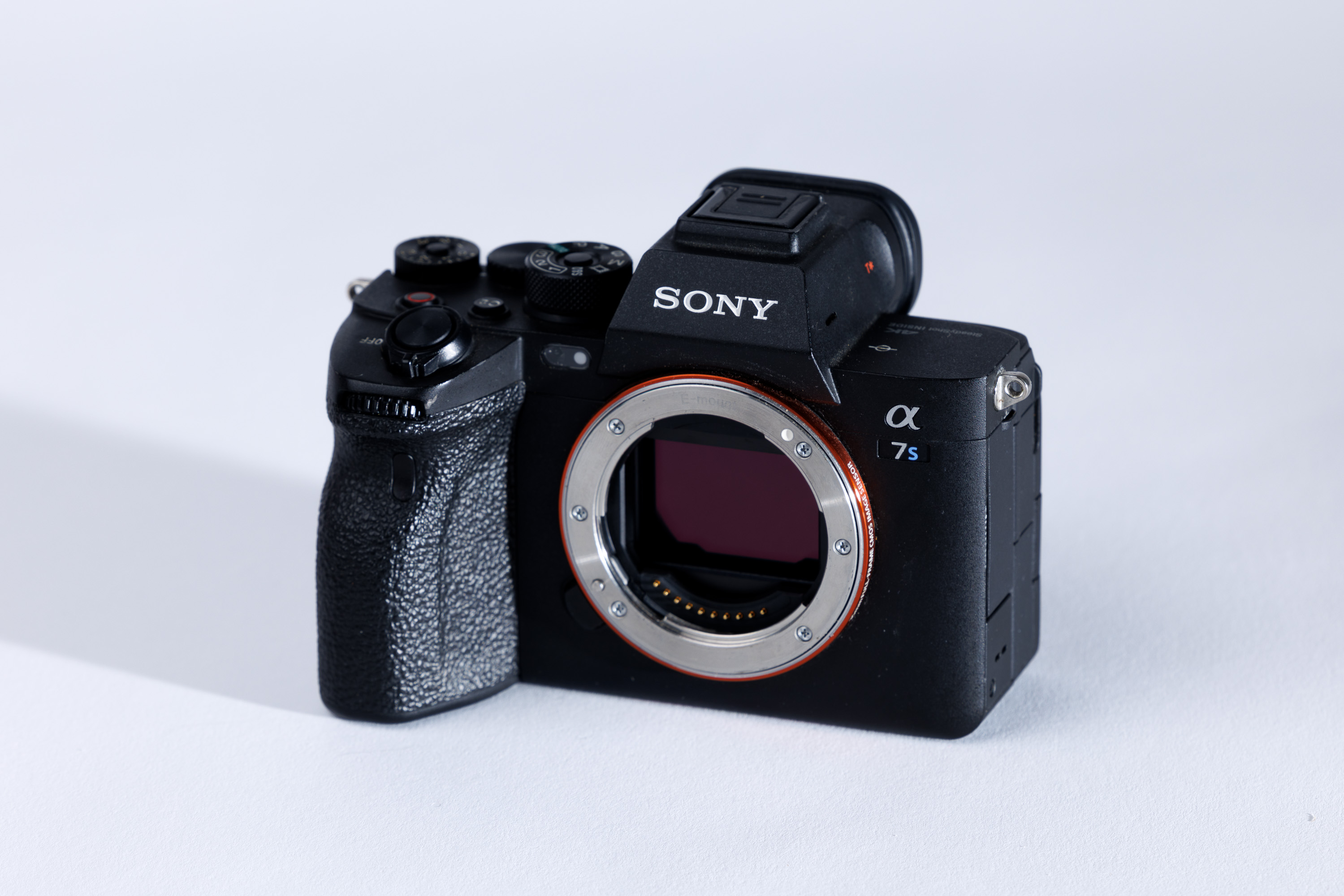 A used Sony A7S III on a white background, with a shadow to the left.
