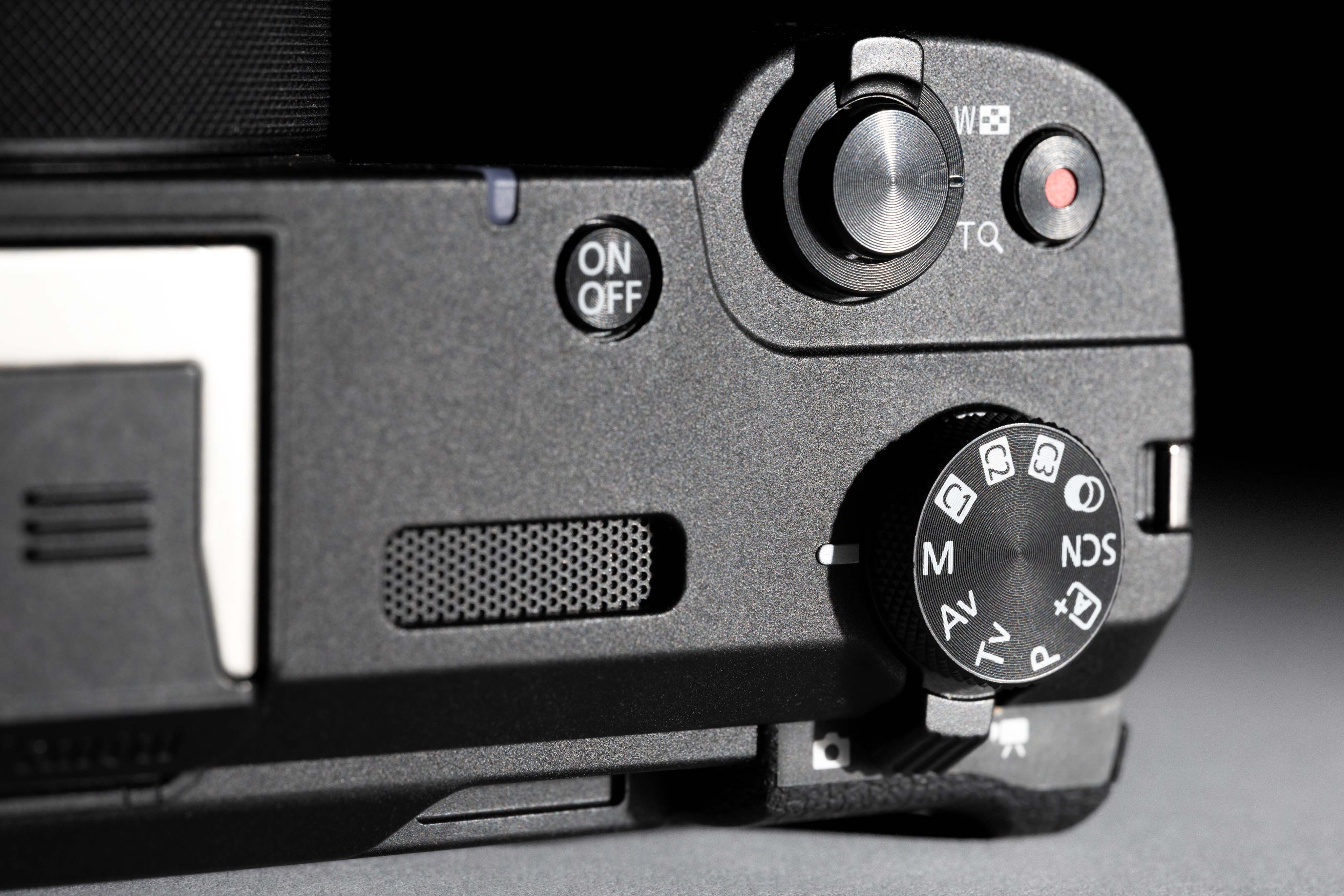 Close-up studio kitshot of the top of a Canon V1 on a black and white background showing a detailed view of built in buttons and dials. Image by Connor Redmond.