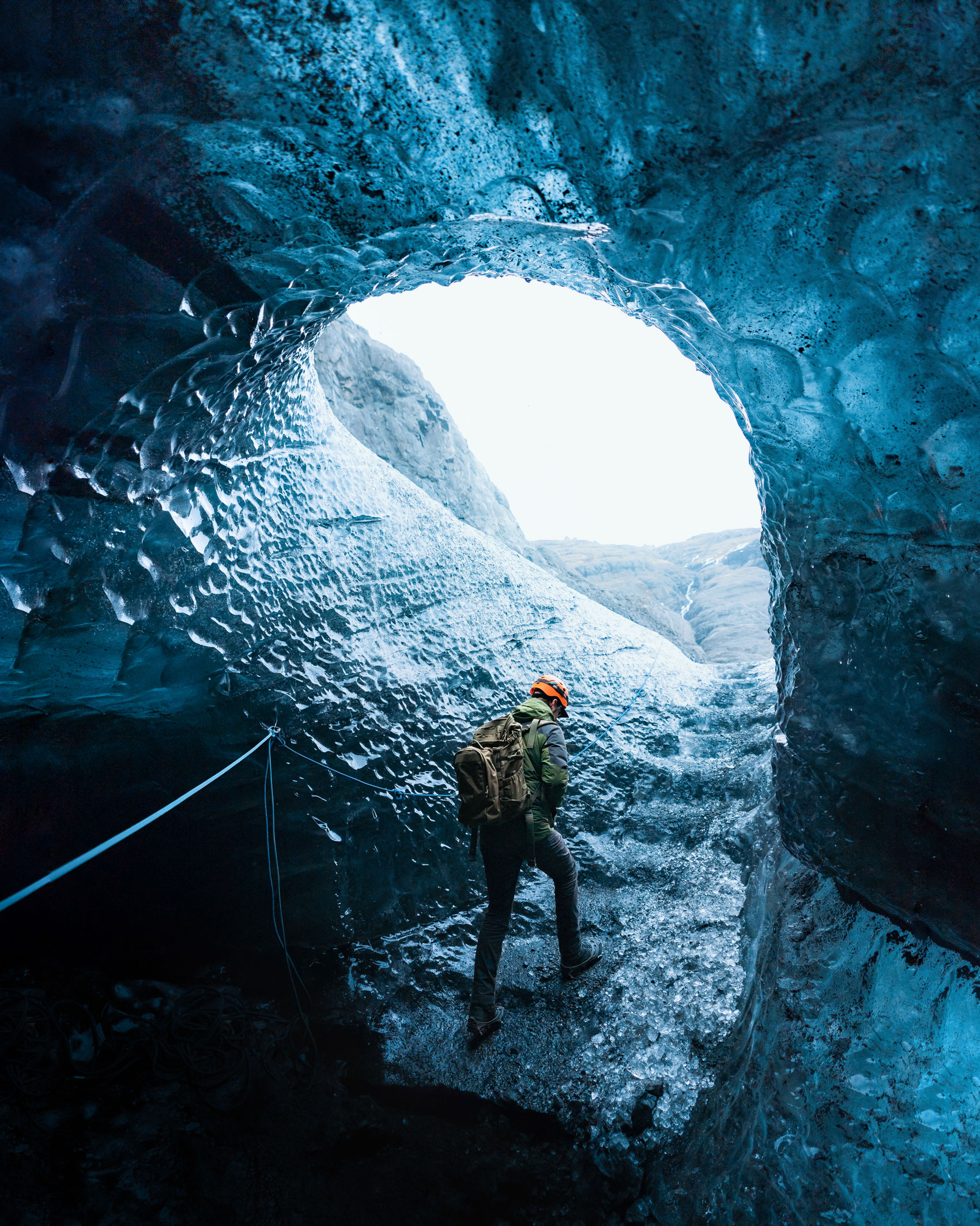 Person walking outside from a glacier cave