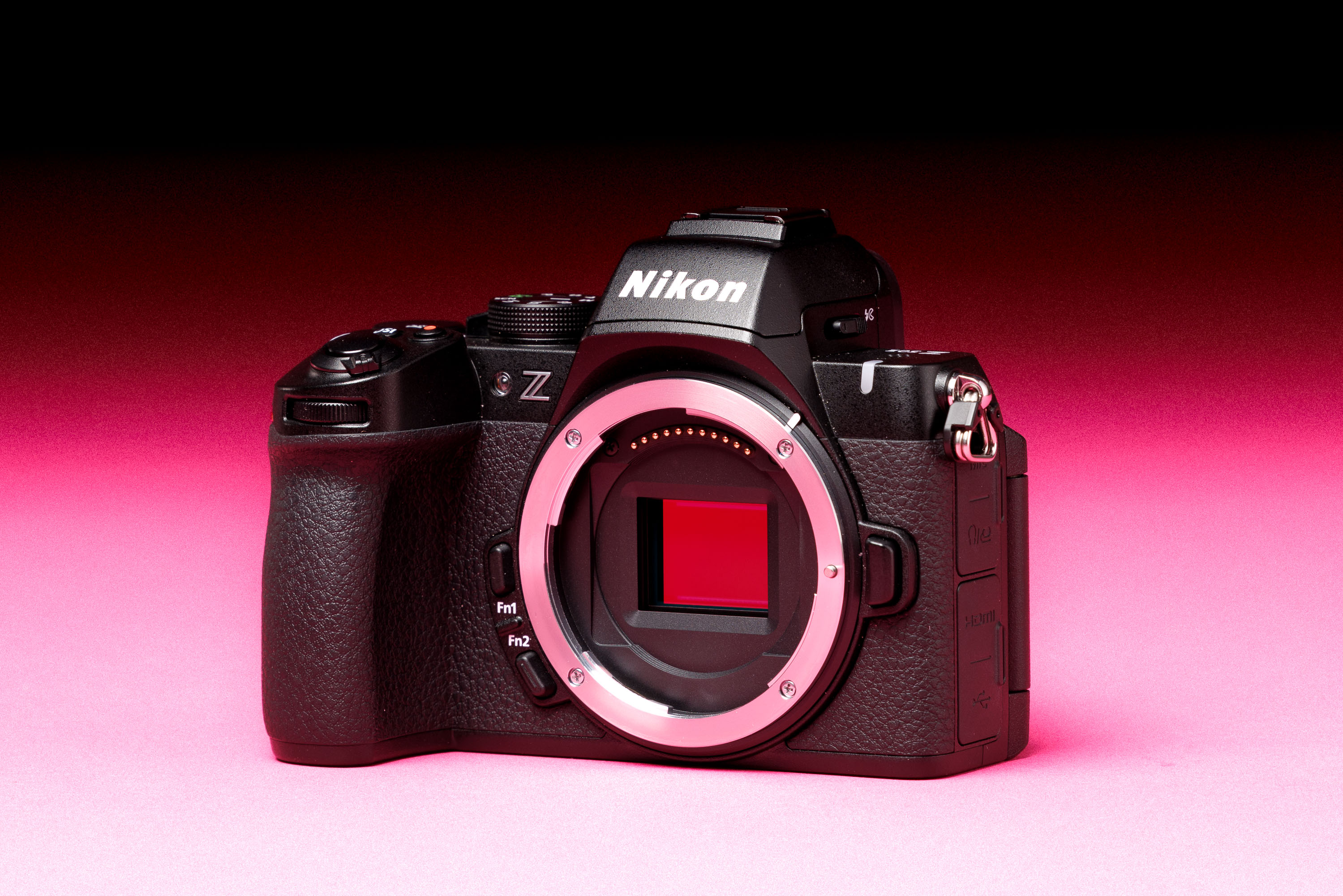 A second hand Nikon Z50 II on a pink and black background
