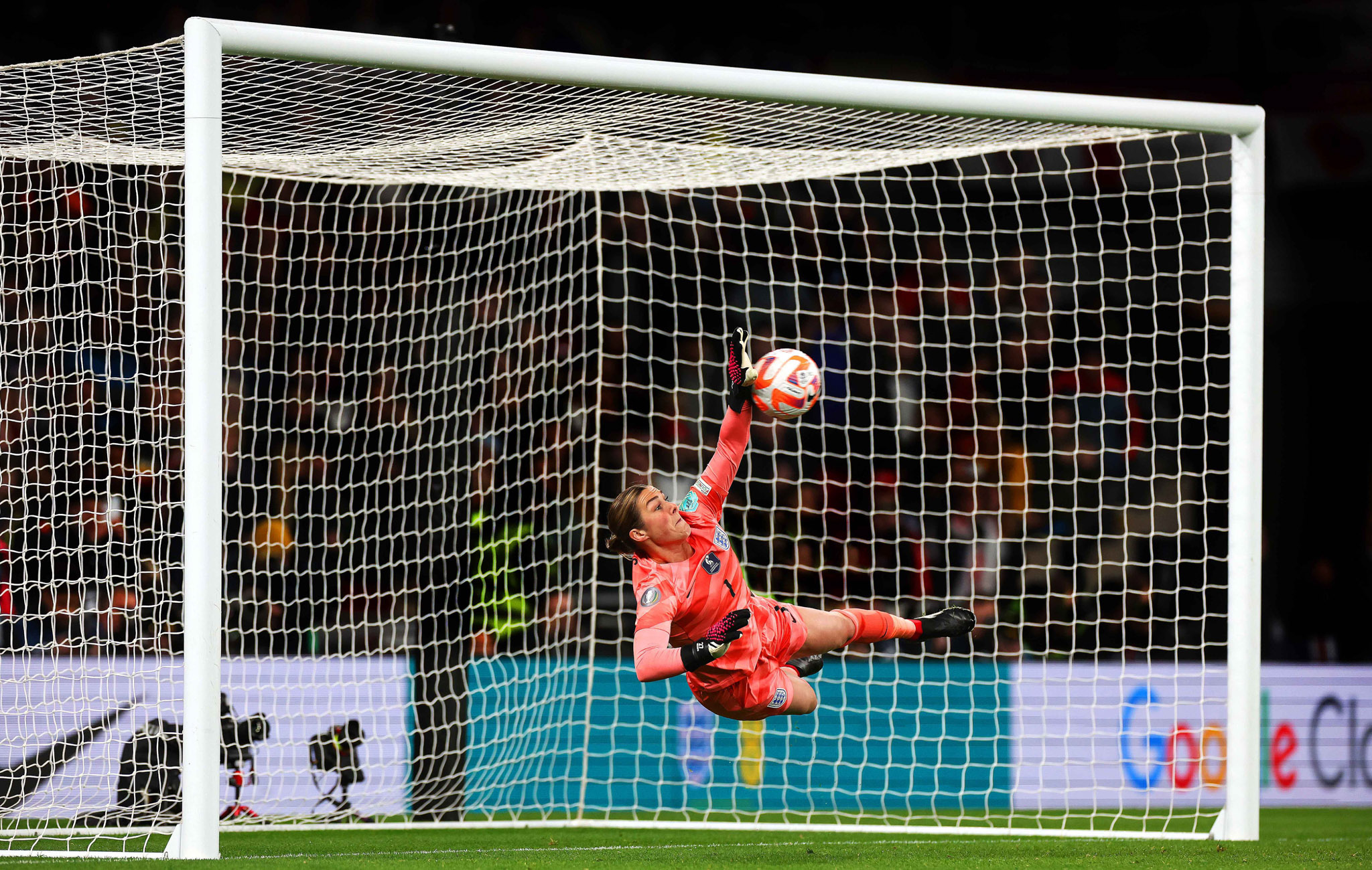 A football goalkeeper saves a penalty shot with one hand. By Marc Aspland.