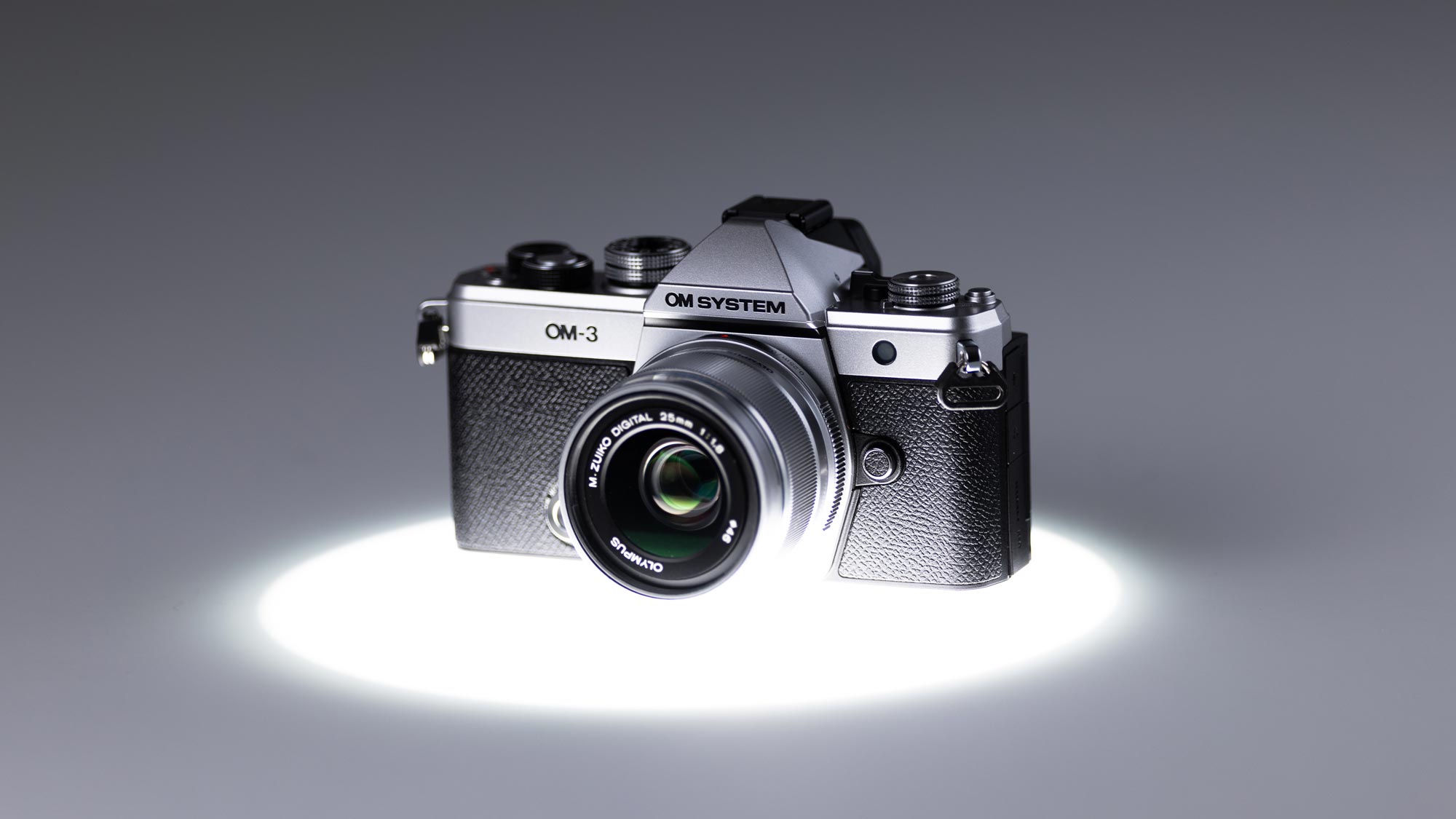 Used OM System OM-3 under a spotlight with a grey background