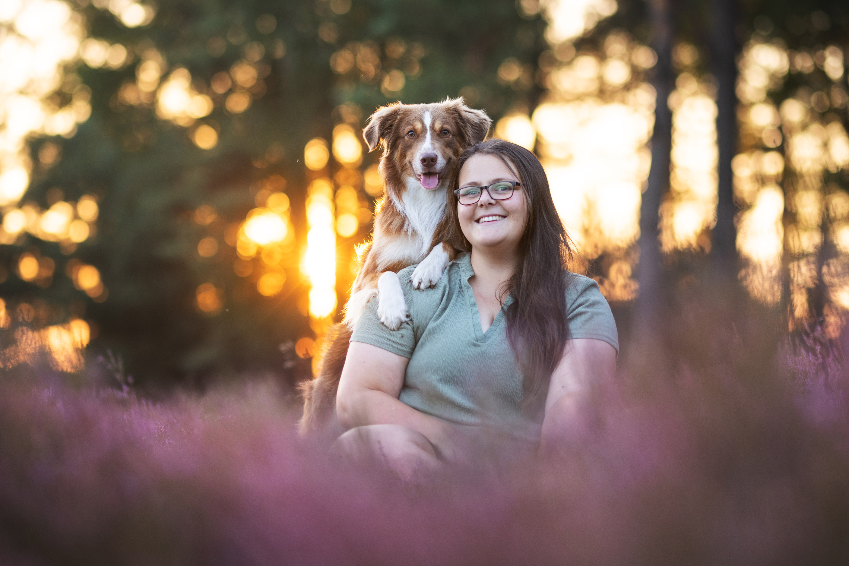Photo of a dog leaning with their paws on a person’s shoulder by Lea Heidt