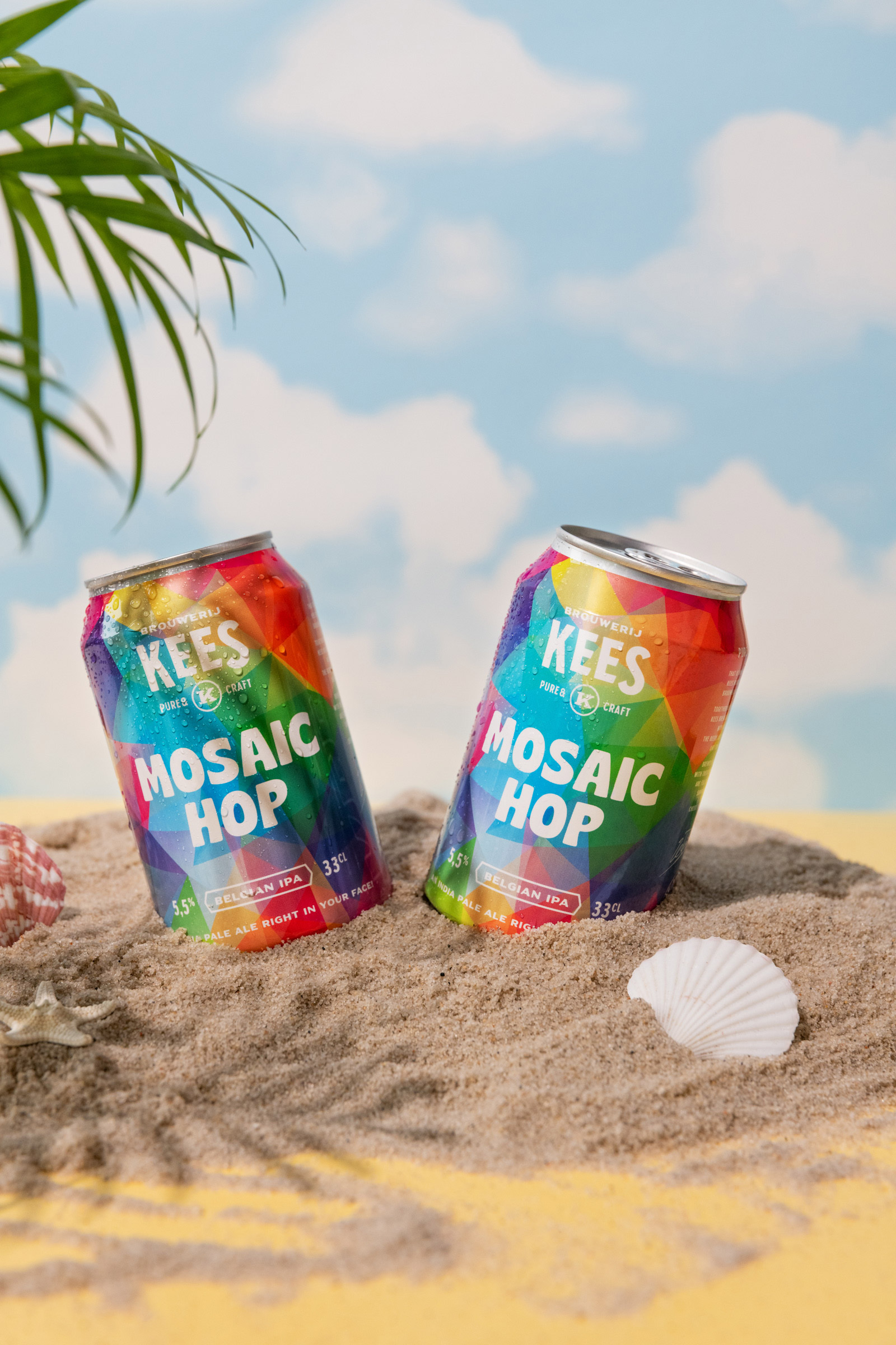 Une image de deux canettes de boissons plantées côte à côte dans le sable.