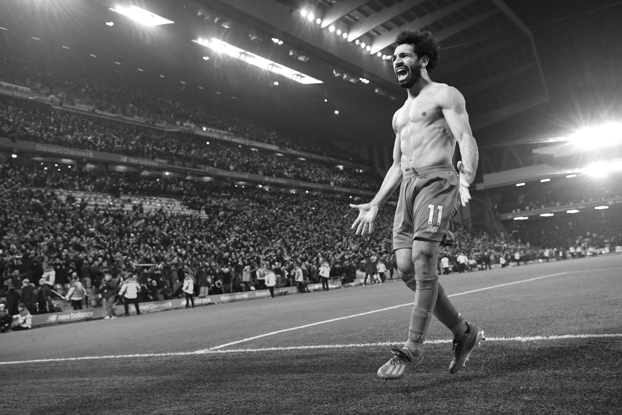 Ein Schwarz-Weiß-Foto von Mohamed Salah vom FC Liverpool, der mit offenen Armen sein Tor feiert, aufgenommen von Ryu Voelkel mit einer Nikon D5