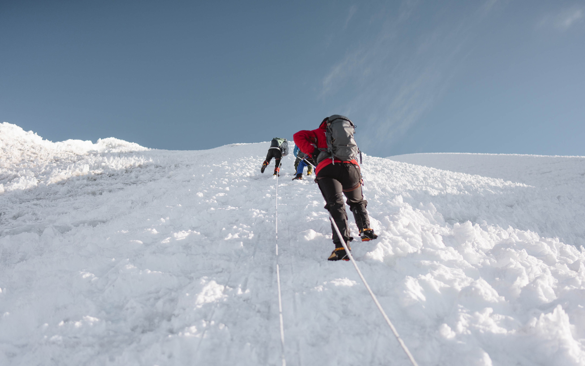 Two climbers scaling a snow-covered mountainside, shot by Jack Anstey with the Sony Alpha A7 IV and the Sony FE 24mm f/1.4 GM.