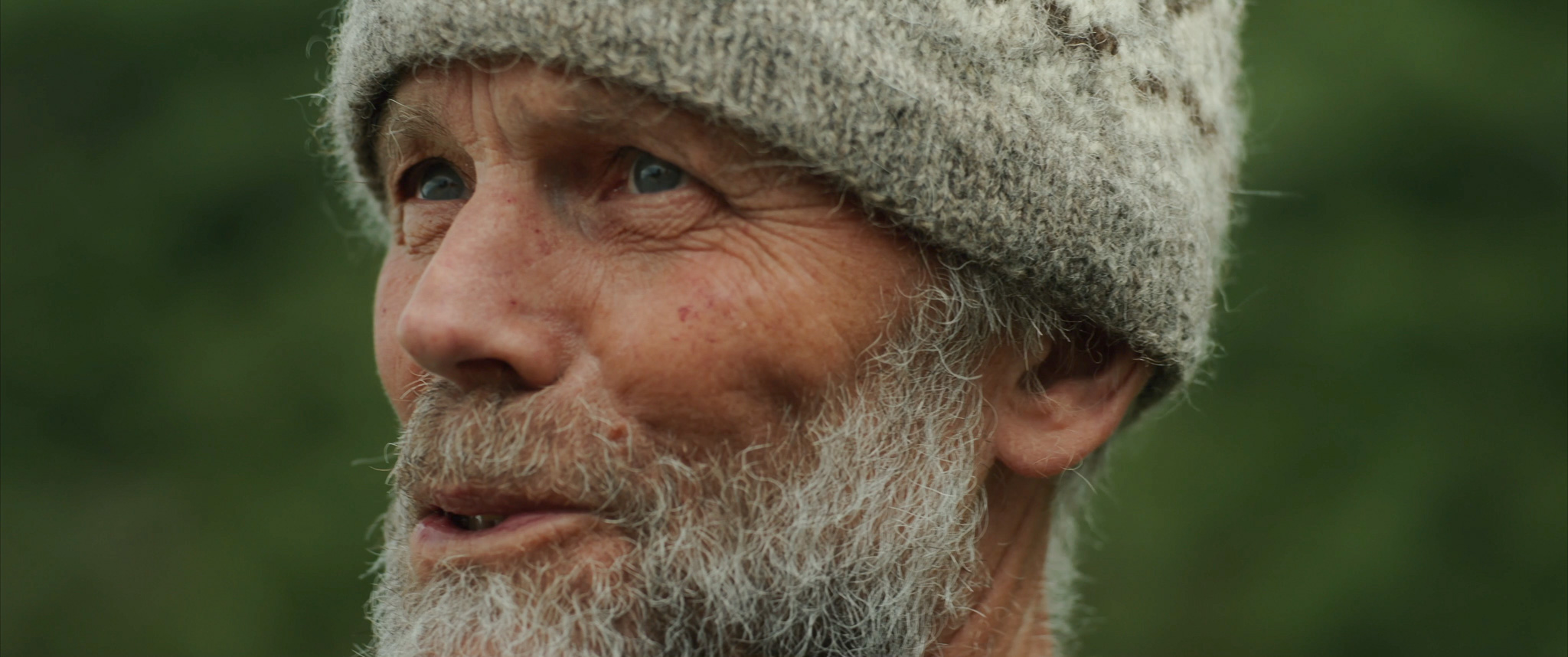 A person being interviewed wearing a woollen hat