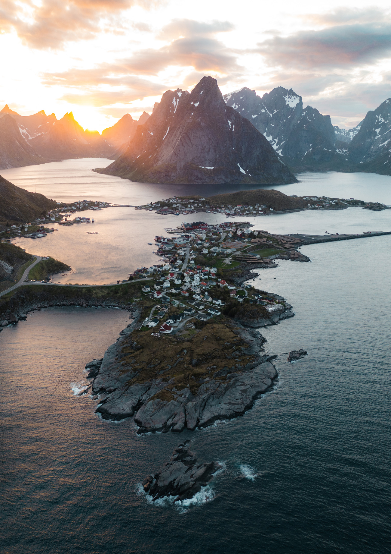 A drone photo of a town surrounded by water and mountains at sunrise in Norway, captured by Jordan Lancaster-Graham with the DJI Mavic II Pro