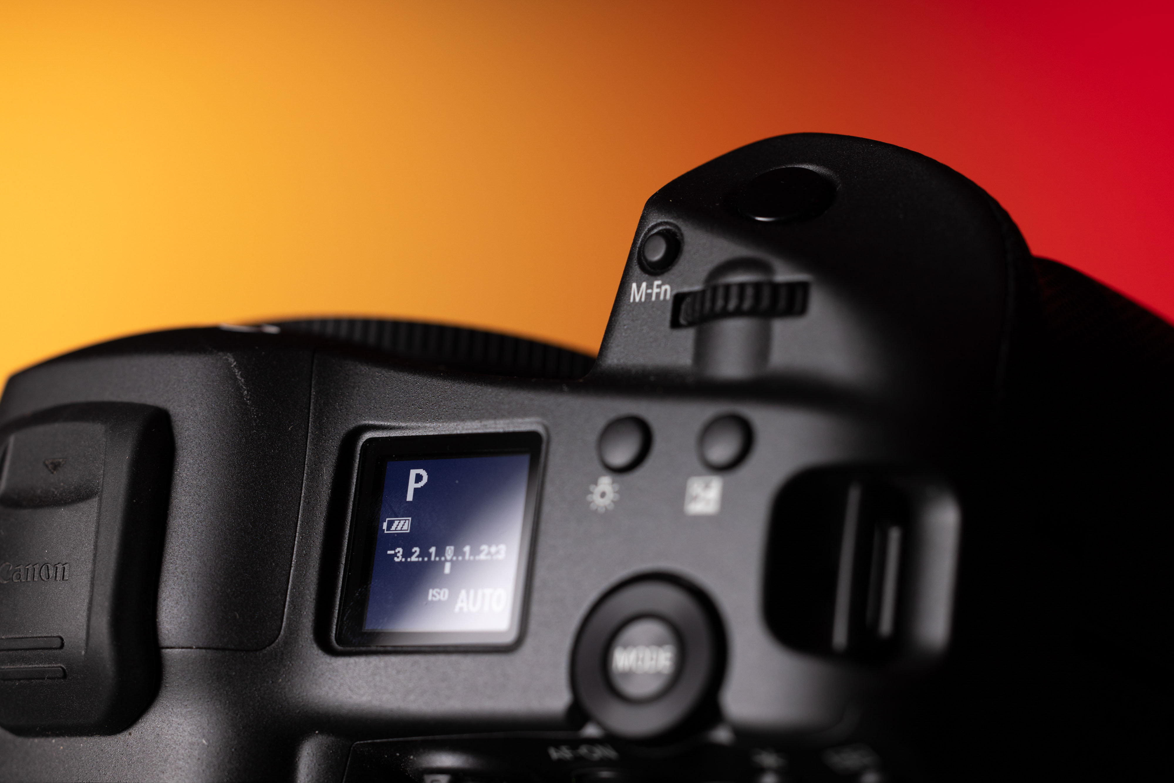 ‘Program’ mode on the Canon EOS R3 on a yellow and red background