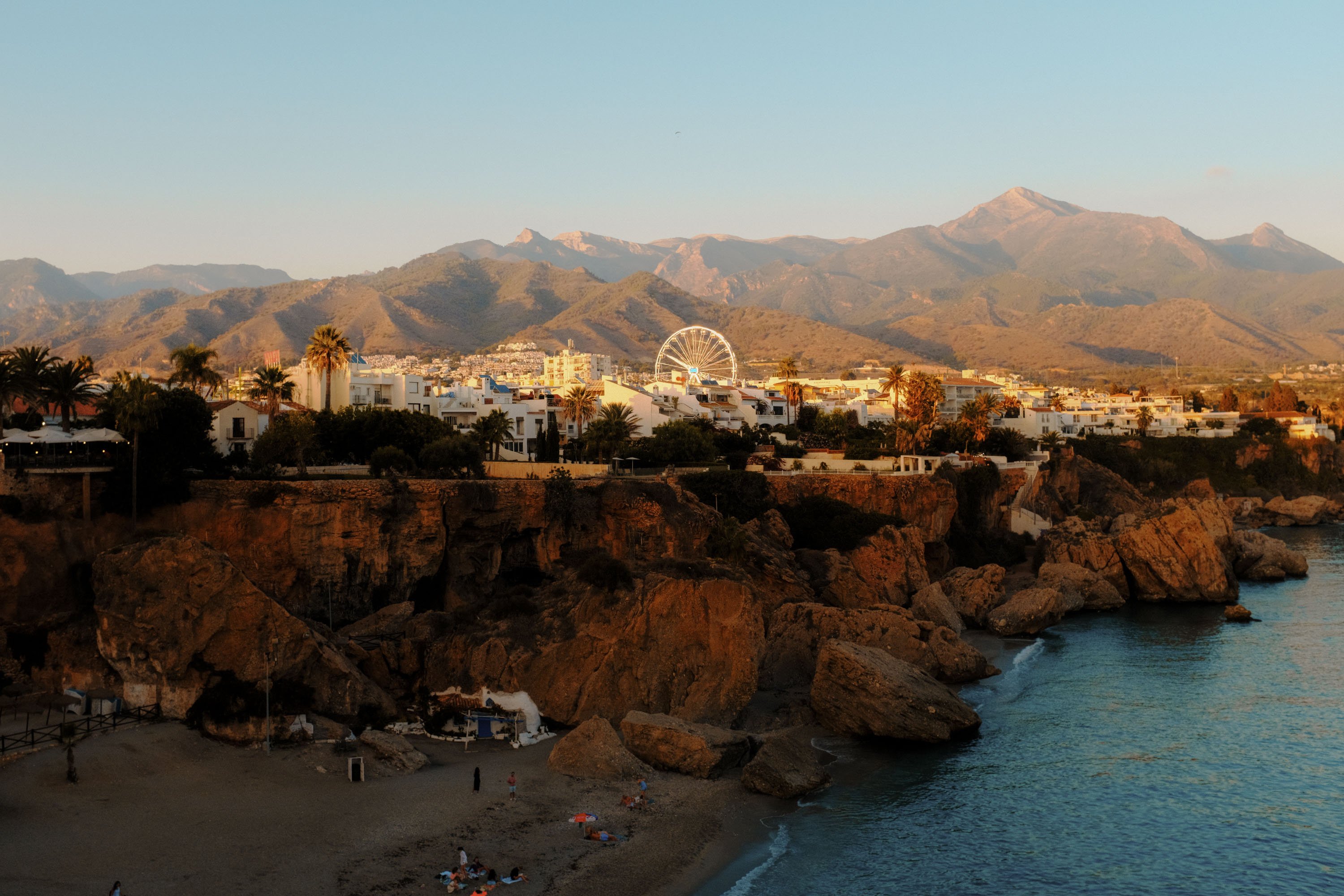 A landscape shot of a town in southern Spain at sunset with a Ferris wheel in the background. By Ian Howorth.