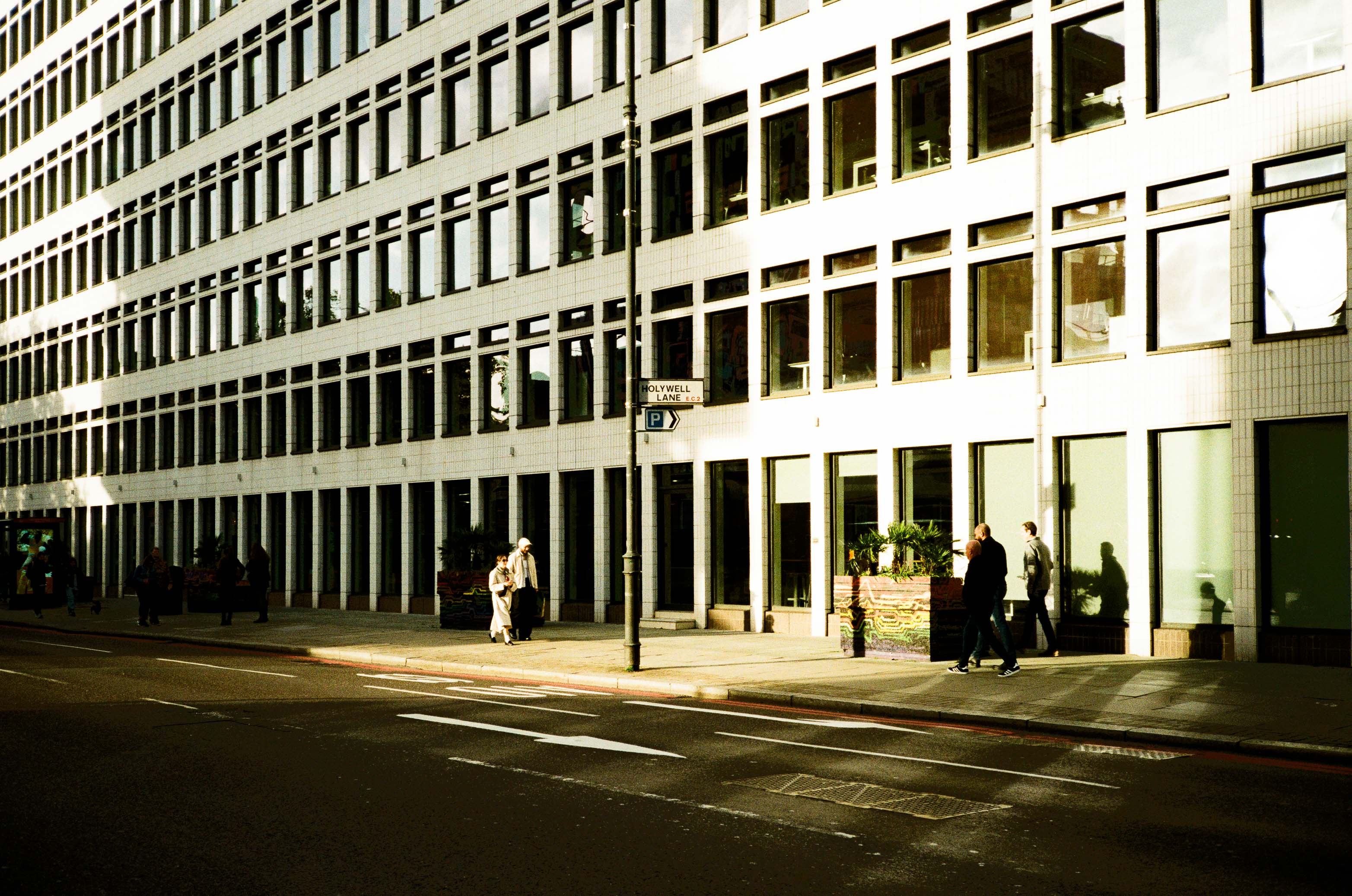 A wide shot of an office building bathed in contrasty light. By Connor Redmond.