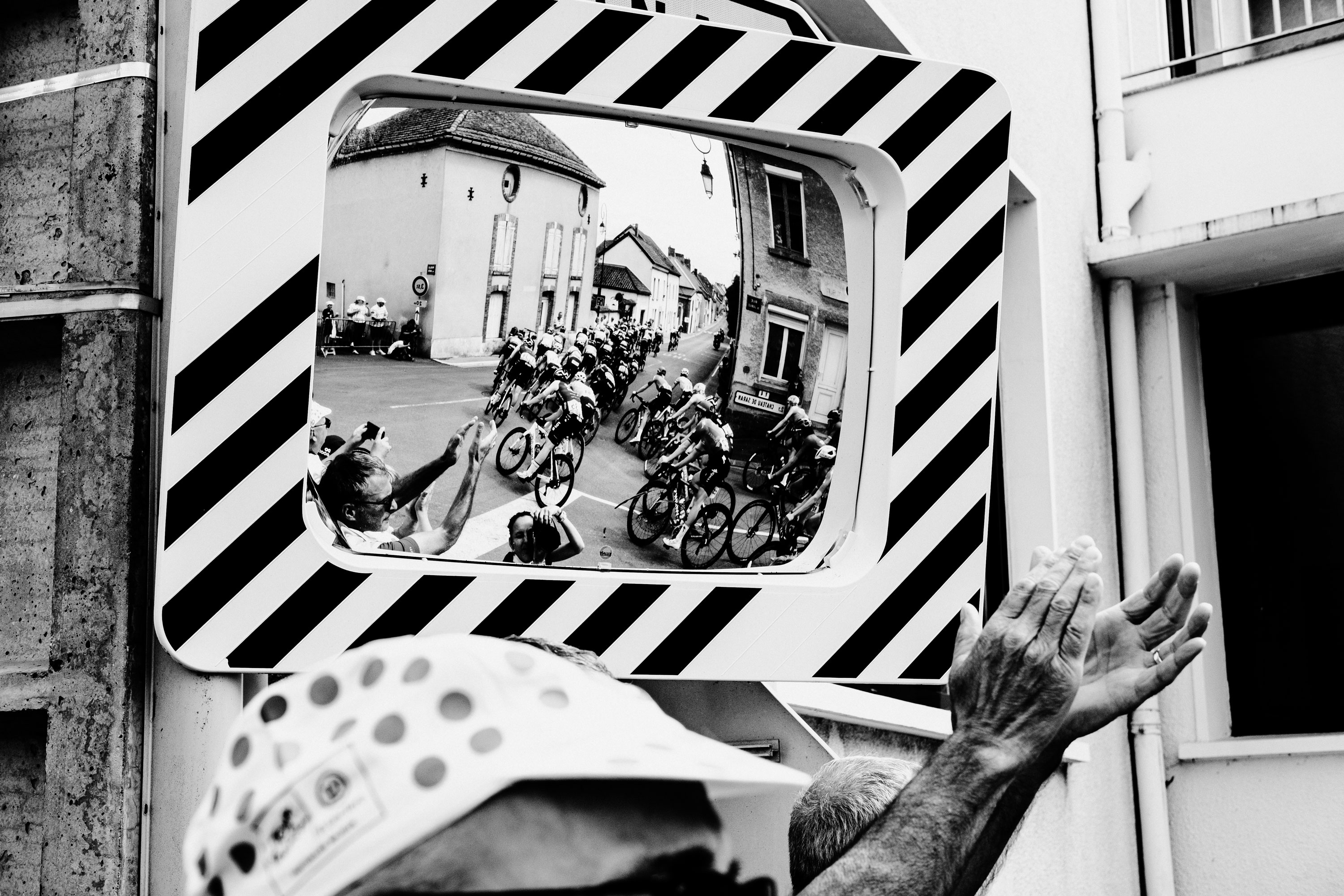Reflection of cyclists in a stripped mirror in the Women’s Tour De France 2022