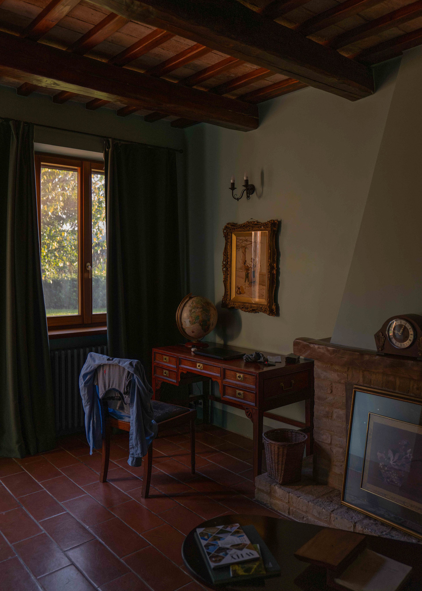 An old Italian villa reading room with a world globe on a wooden desk

