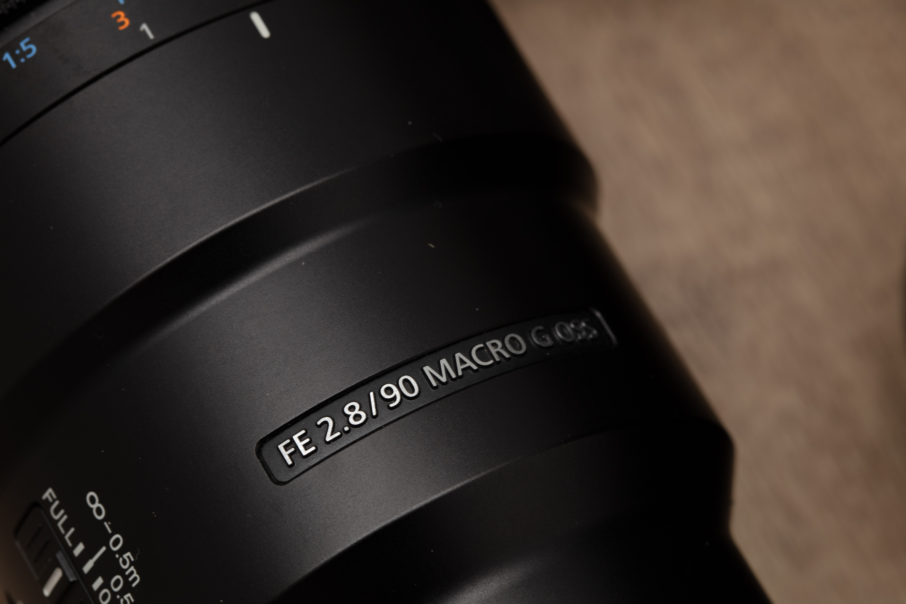Close-up image of a FE 2.8/90 macro camera lens.


