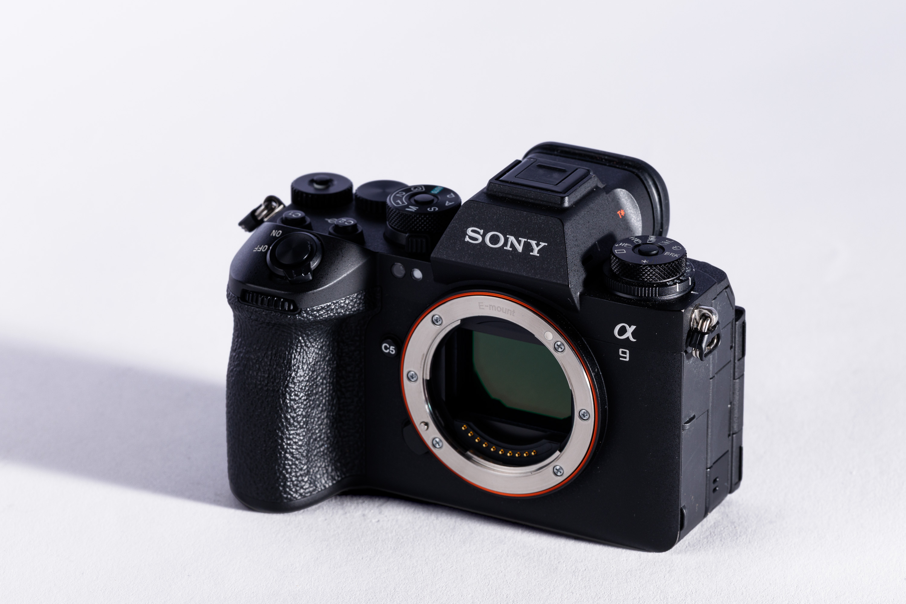 A used Sony A9 III body on a white background, with a shadow to the left. 