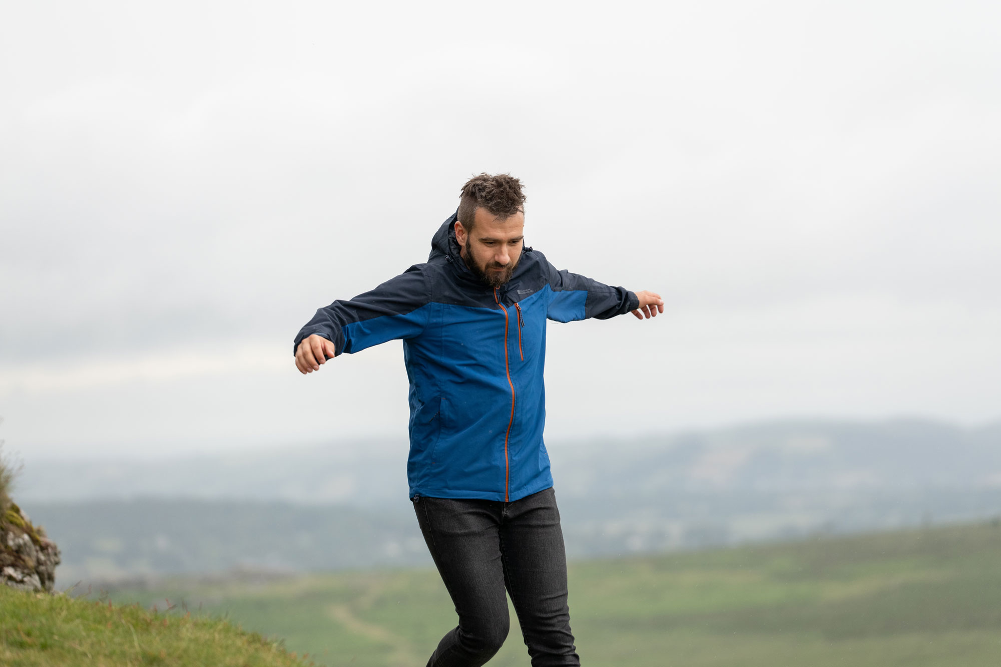 Jakub running and hiding with his arms outstretched to test the tracking ability of the Panasonic S1R II. Photo by Amy Moore with the Panasonic S1R II.