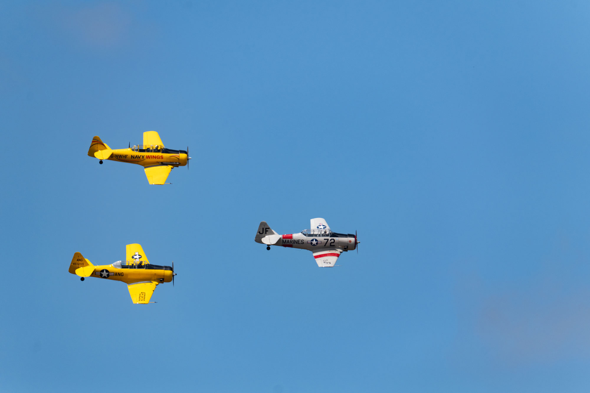 Three planes flying in the air in a triangle formation, photo by Amy Moore with the Panasonic S1R II.