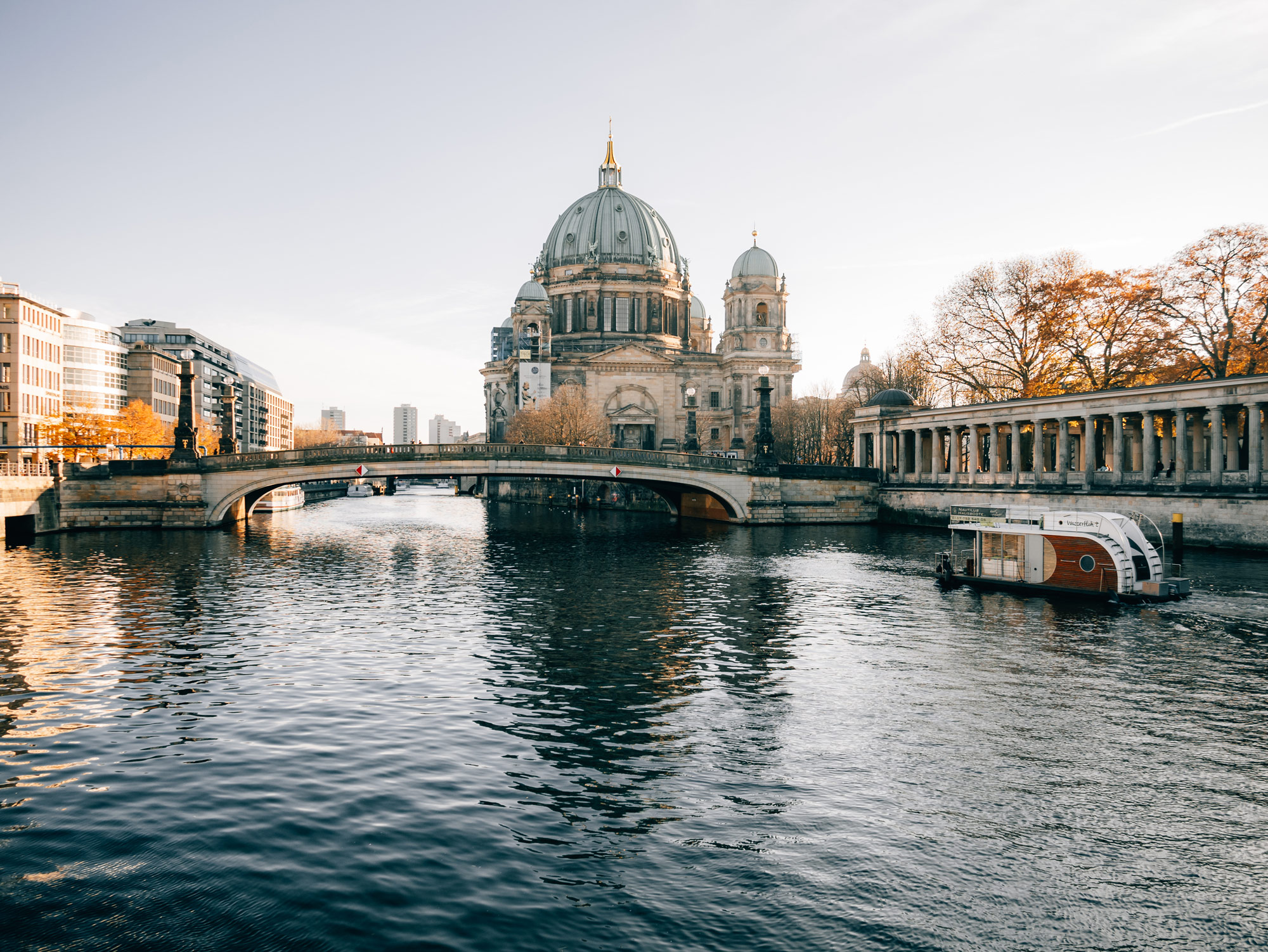 An old stone building with a circular dome roof next to a river, shot by Emily Lowrey with the Panasonic Lumix DC-GX800.