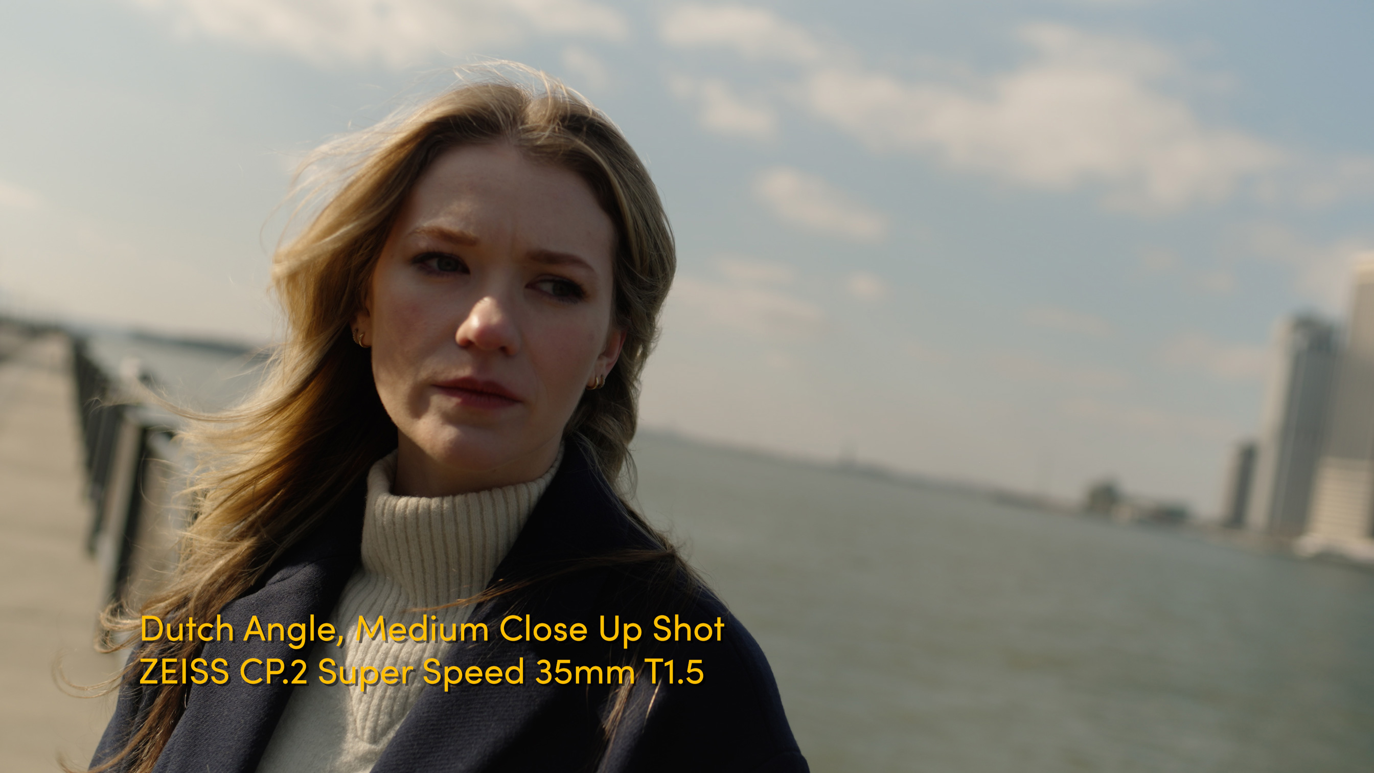 Example dutch angle shot of blonde woman in front of water