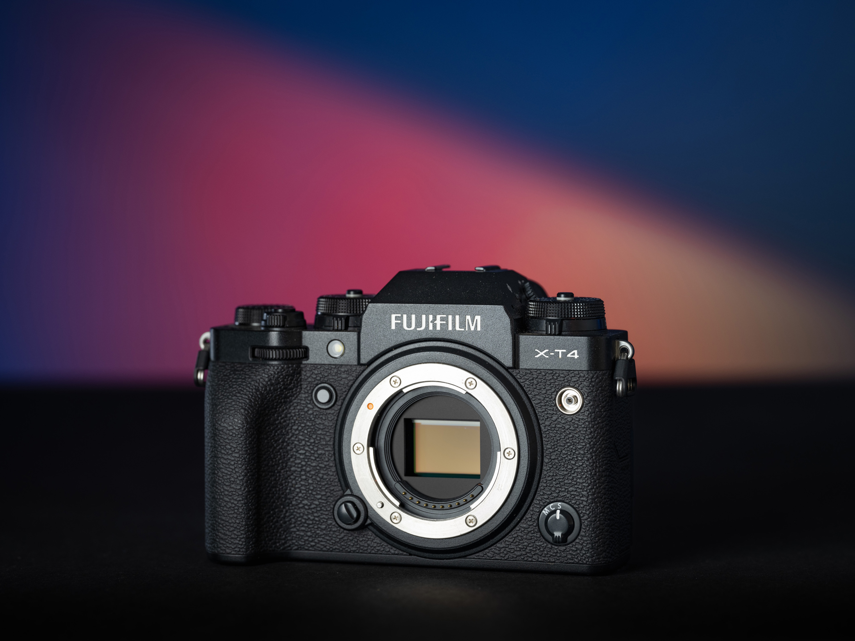 Fujifilm X-T4 on a blue and pink background.