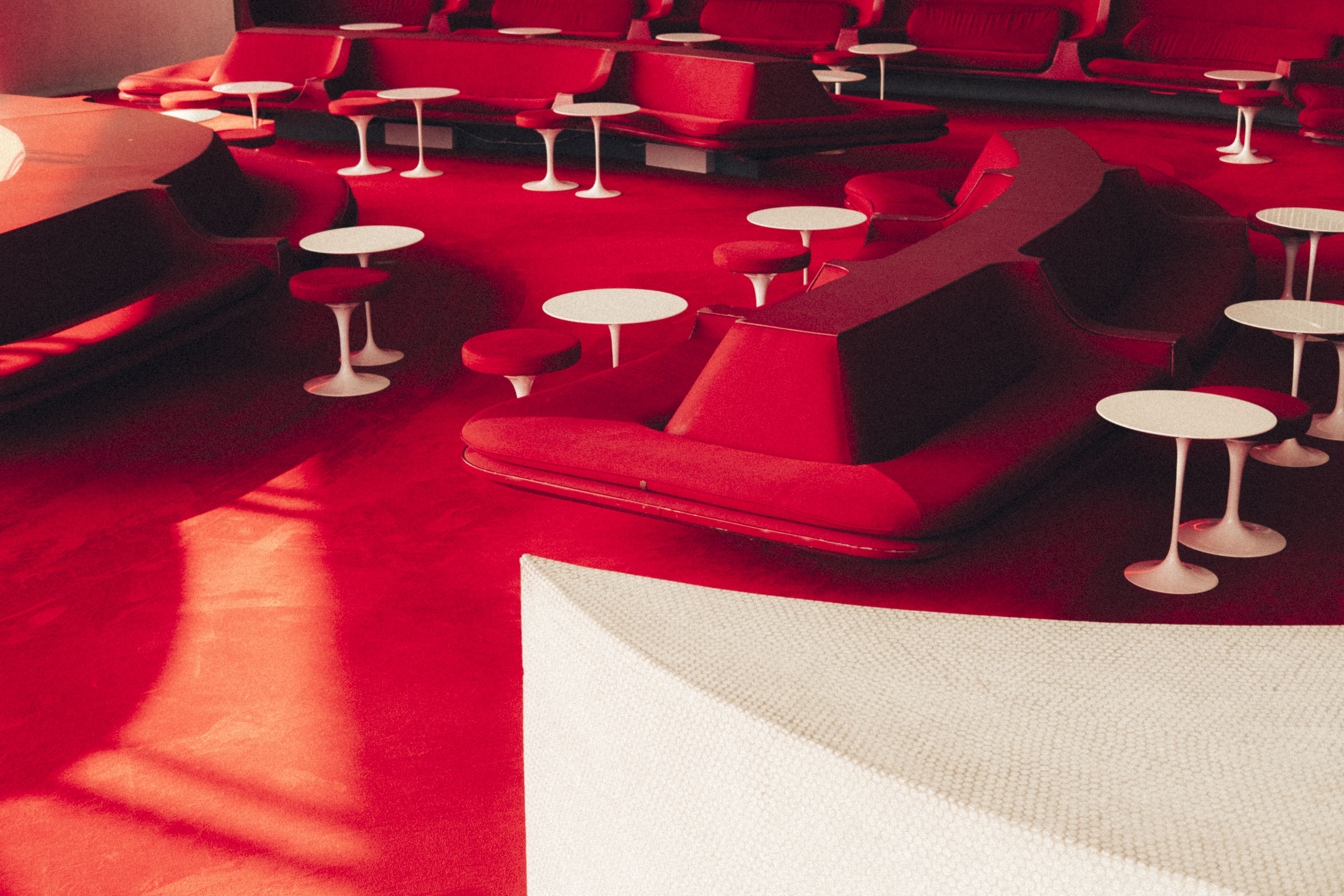 Red mid-century sofas, chairs and tables in a waiting lounge at the TWA Hotel in JFK Airpot, New York. Shot on the X-Pro 3 by Ian Howorth.