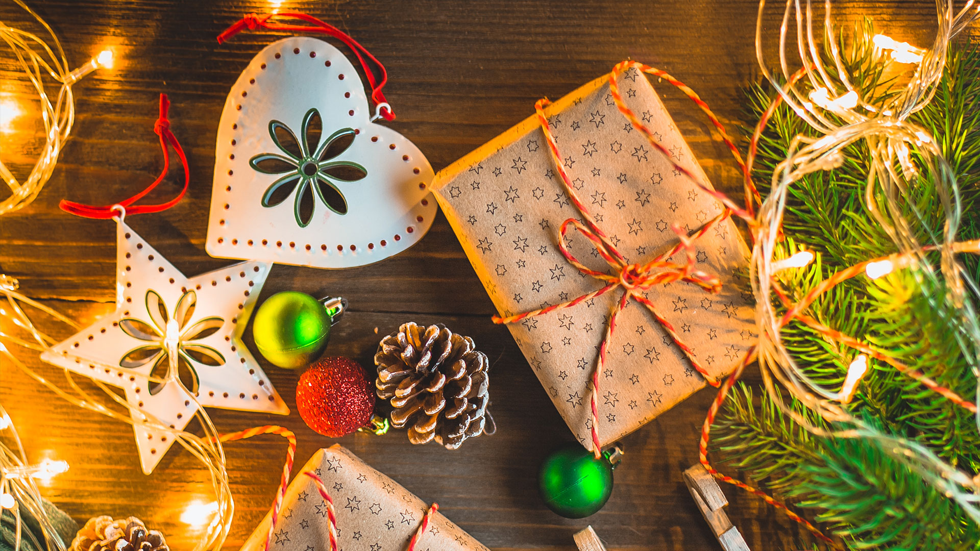 Gifts and festive decorations on a wooden surface