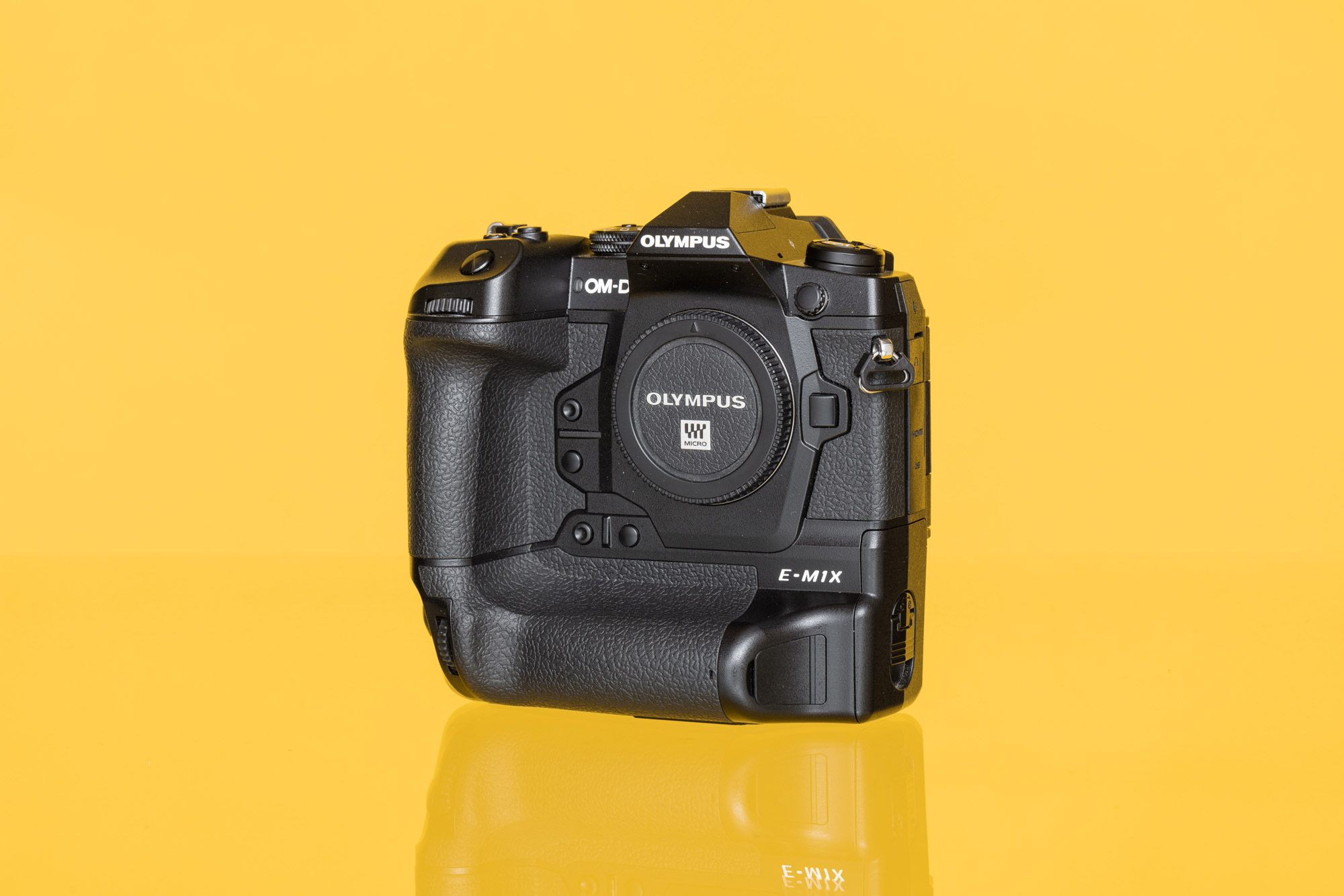 Olympus OM-D E-M1X against a yellow background