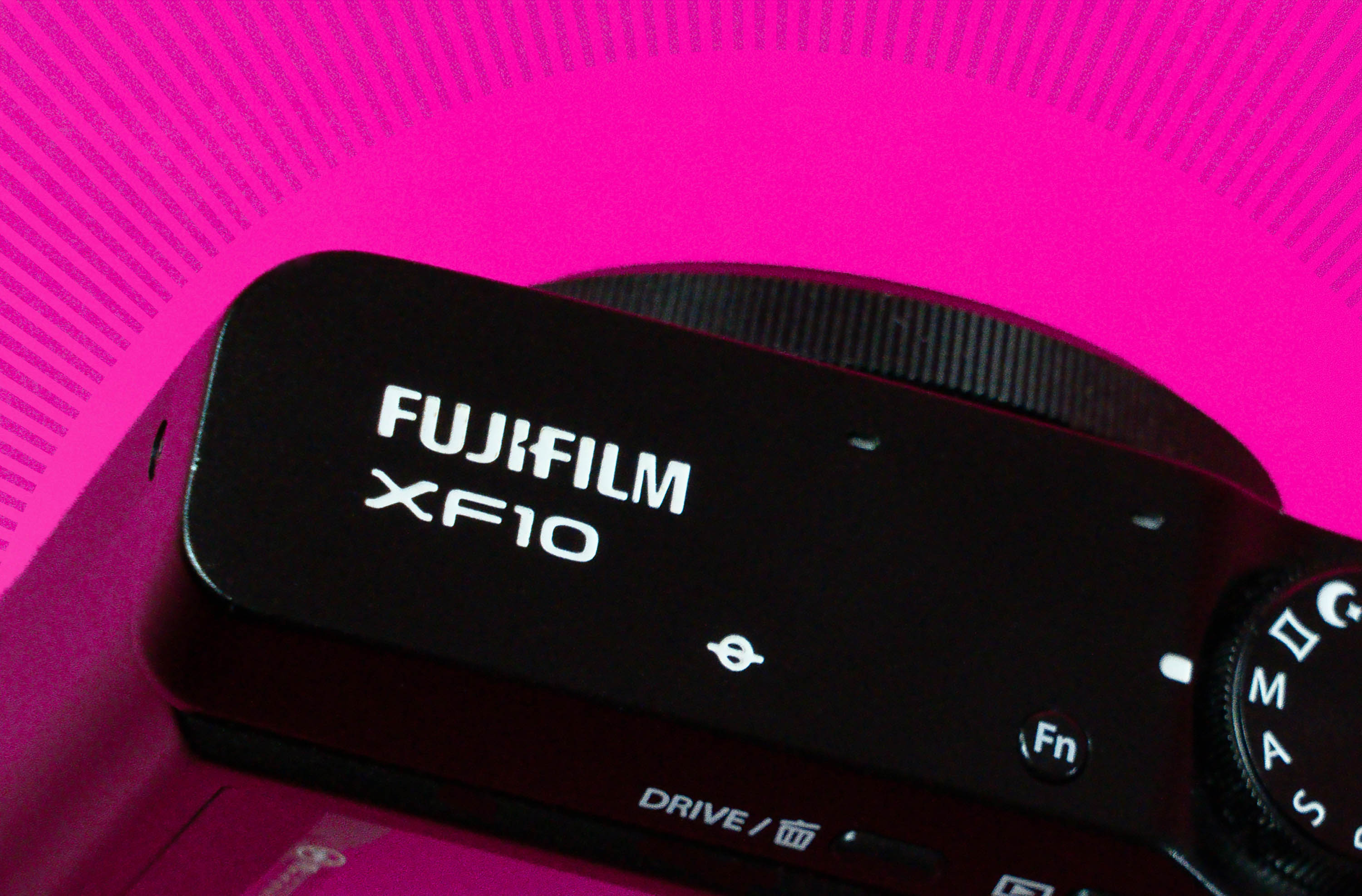 Fujifilm XF10 from above on a pink background