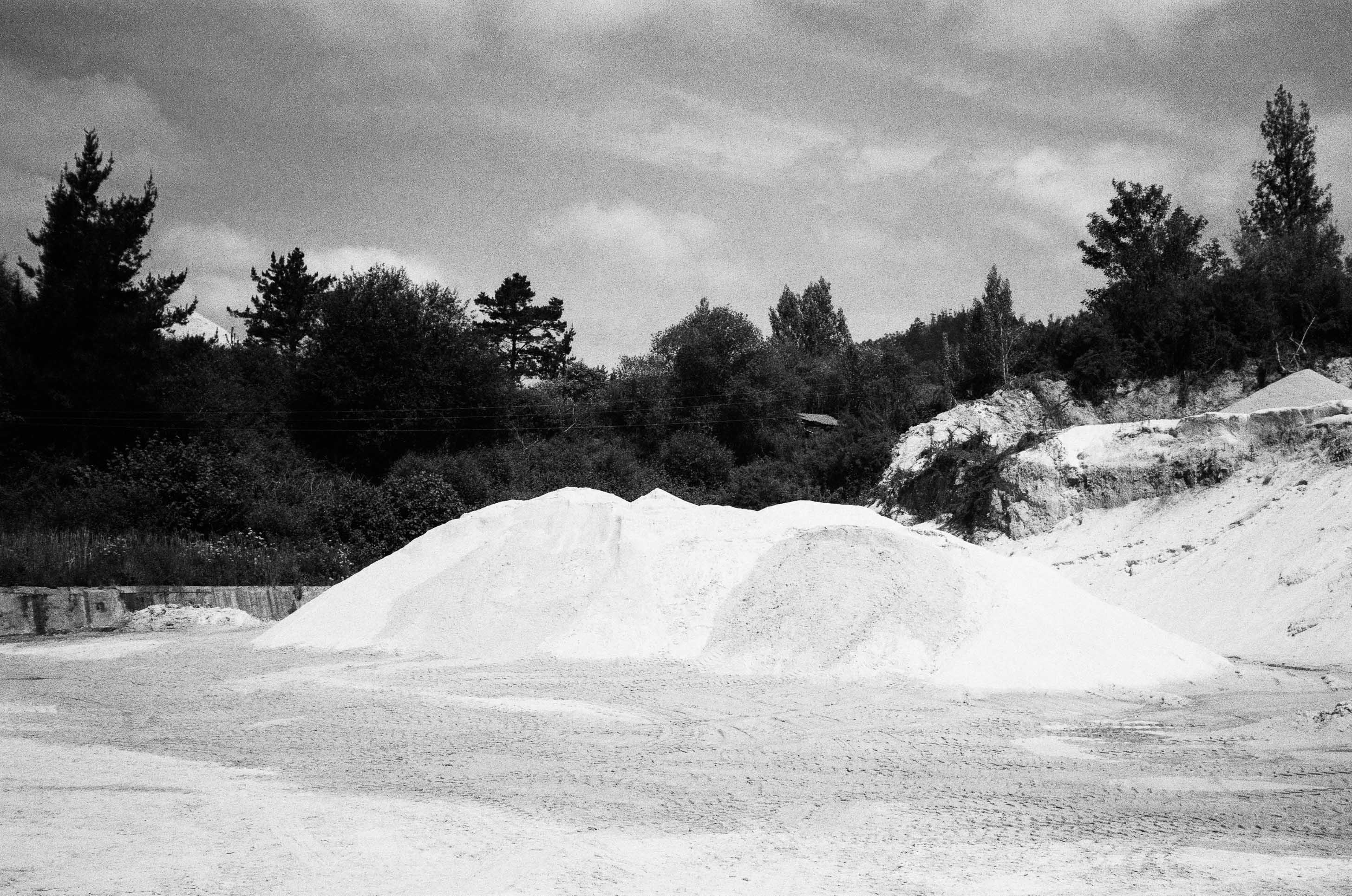 A big pile of what looks like chalk or white rock against. By Connor Redmond.