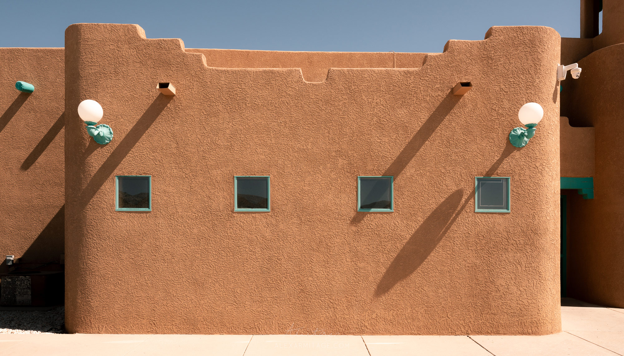 Photo of the side of a New Mexico building with turquoise windows taken by Alex Armitage on a Nikon Z8.