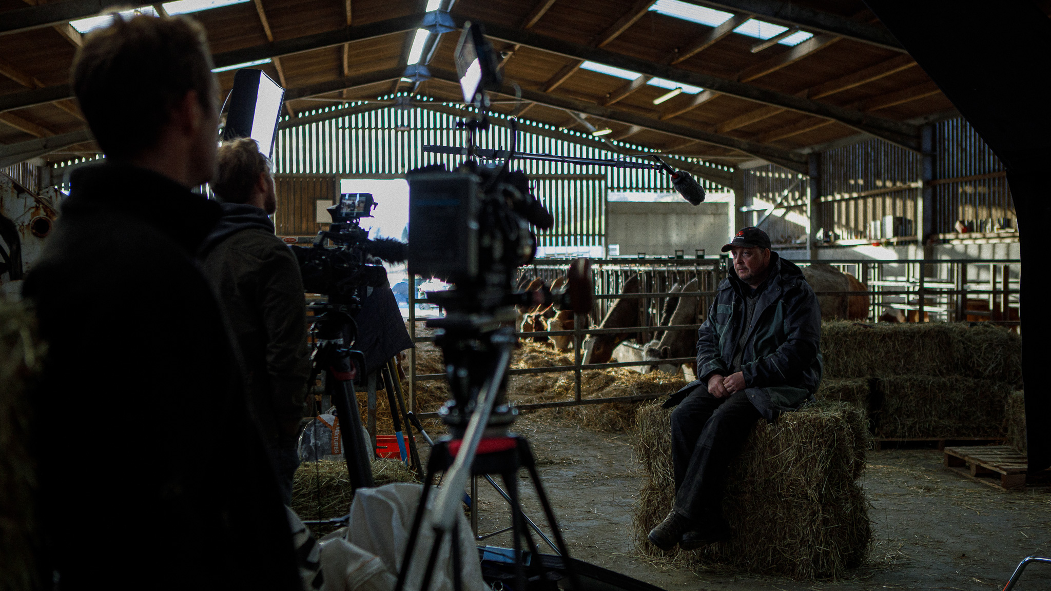 Behind-the-scenes shot of an interview in a farm barn