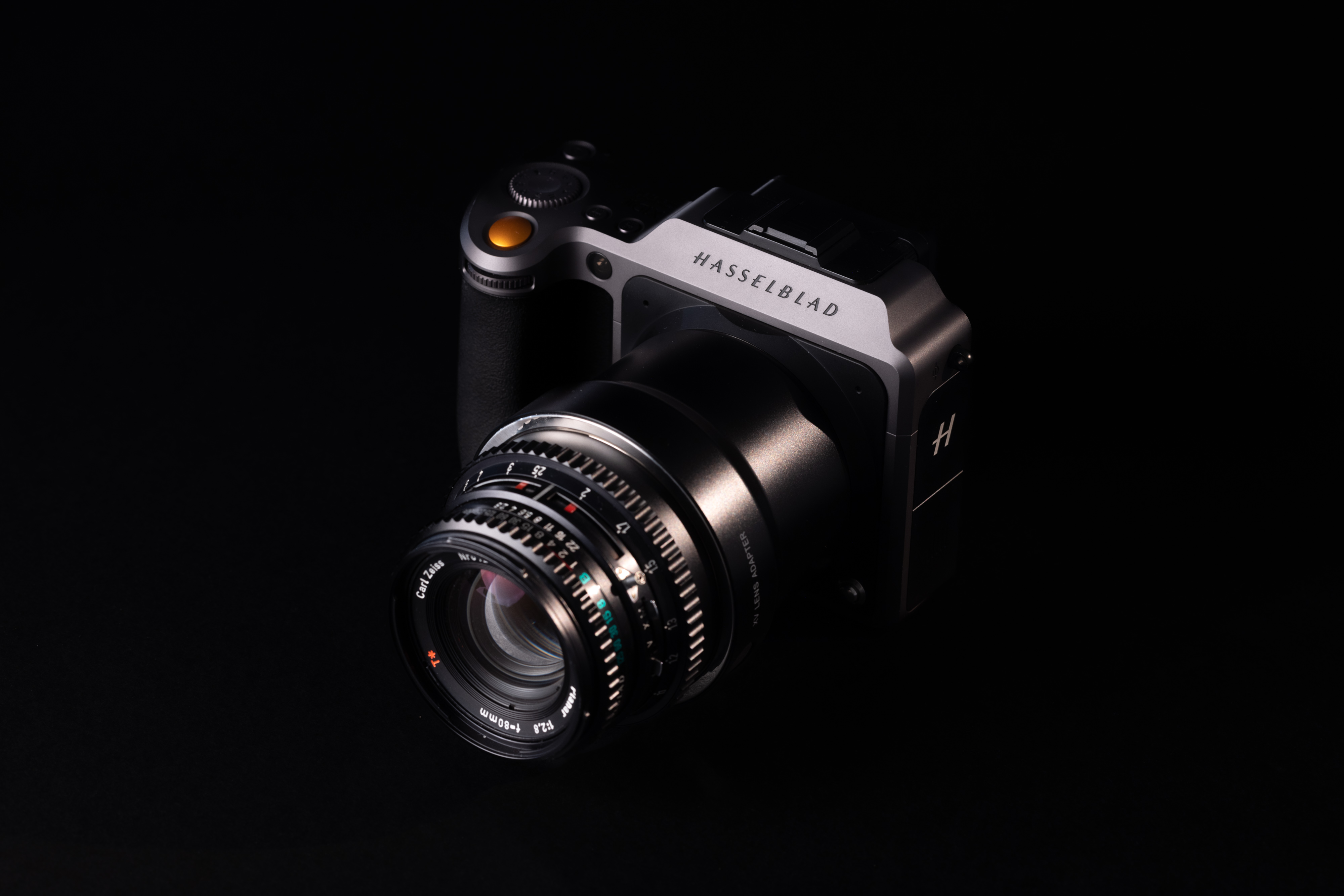Een foto van een Hasselblad XD II met een Carl Zeiss 80mm f/2.8 V-serie lens Hasselblad XV converter op een zwarte achtergrond.
