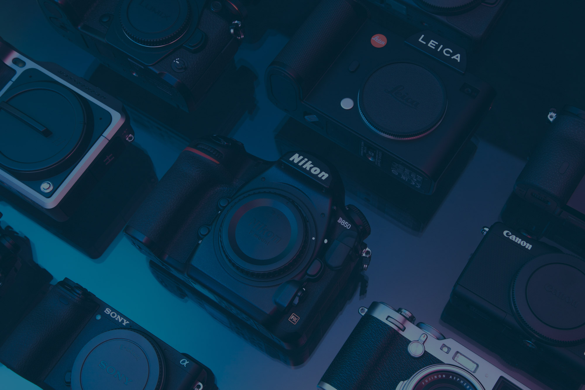 Camera flatlay with blue overlay 