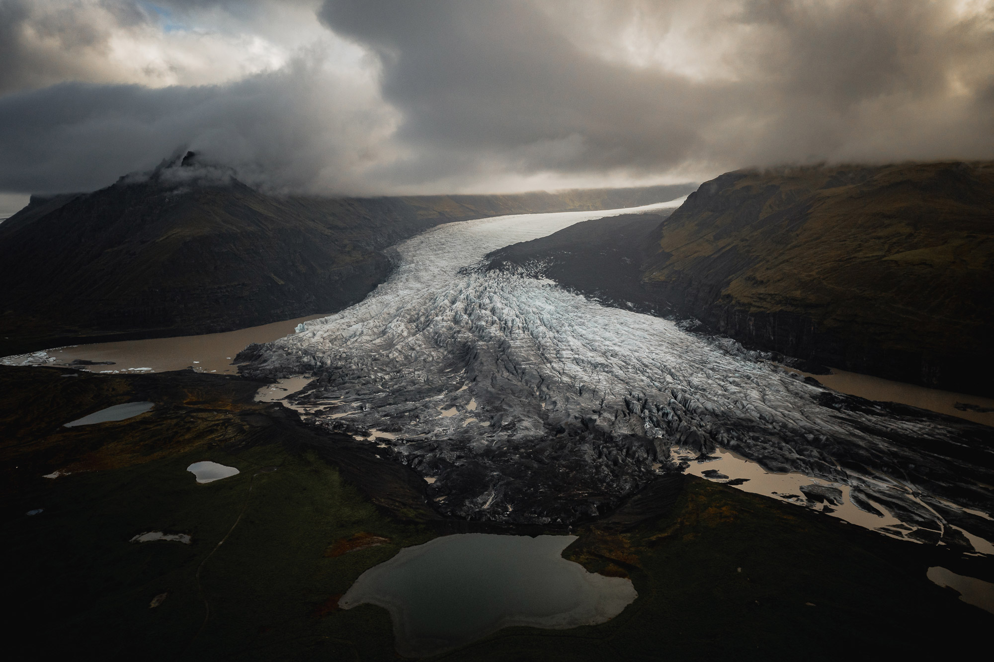 A aerial drone photo of a frozen river running between hills in Iceland, shot by Paul Watson with a DJI Mavic 2 Pro