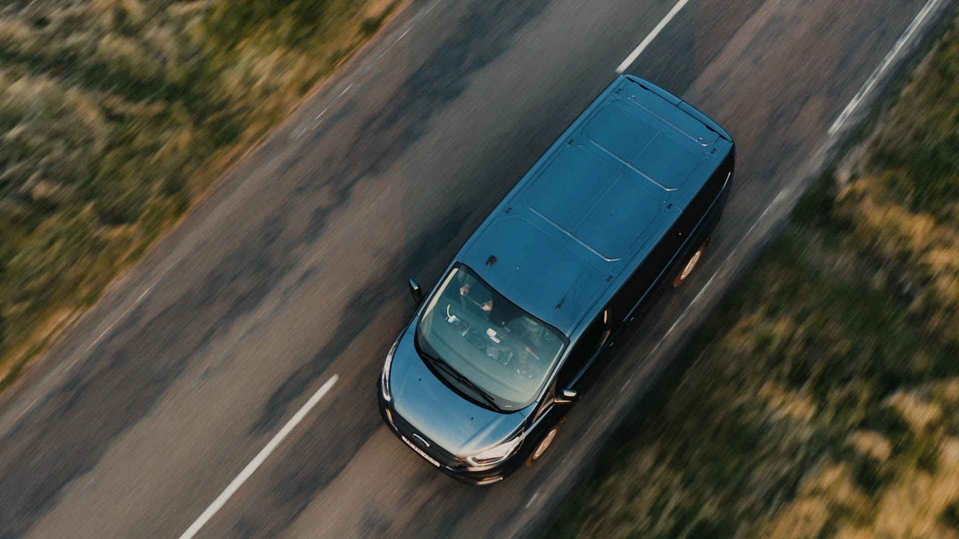 Een dronebeeld van een busje dat over een weg rijdt, een stilstaand beeld uit de korte film Truluck van Matt Cannon en Jake Smallwood.
