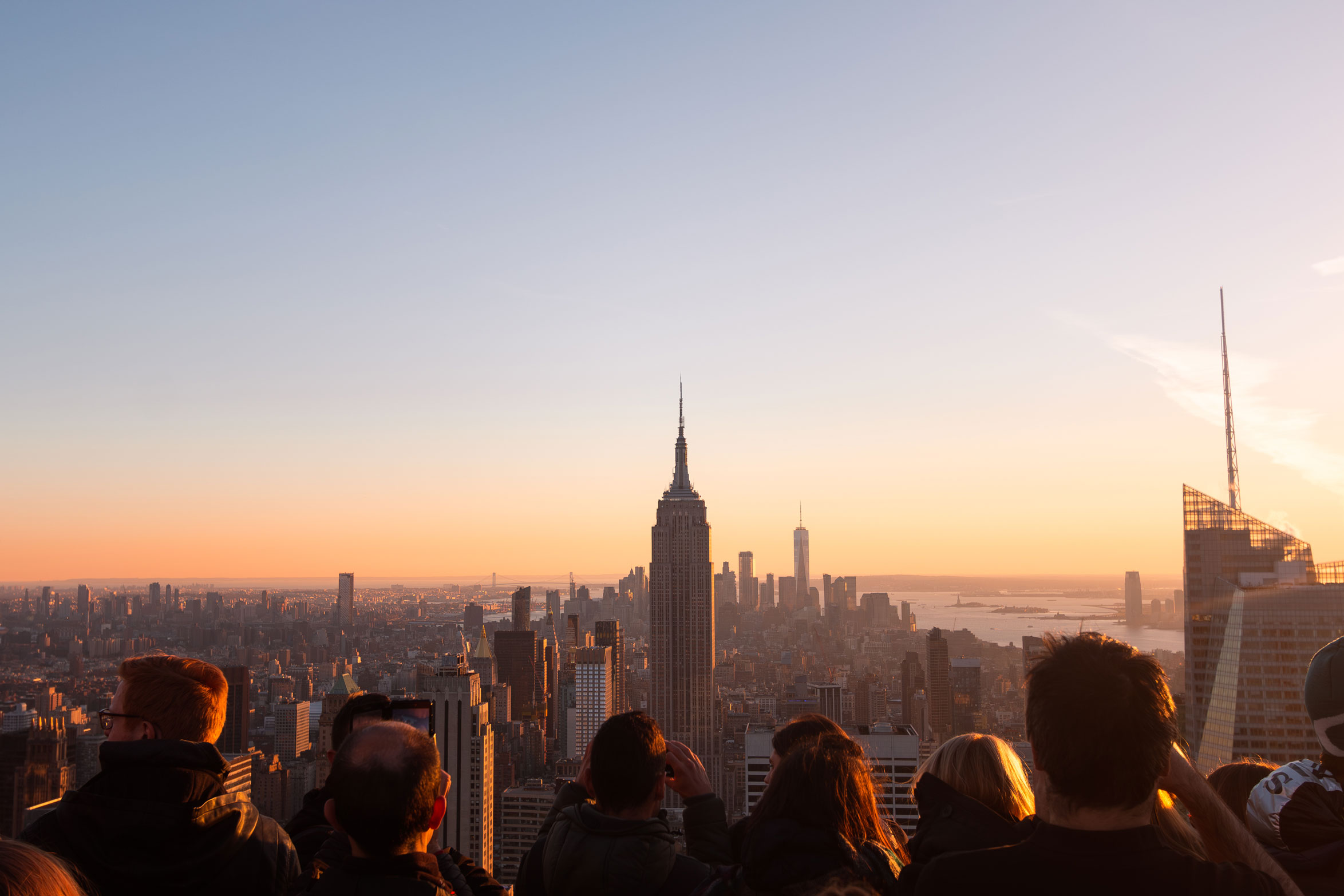 A photo from New York City’s Top of the Rock in Midtown Manhattan featuring the Empire State Building at sunset.