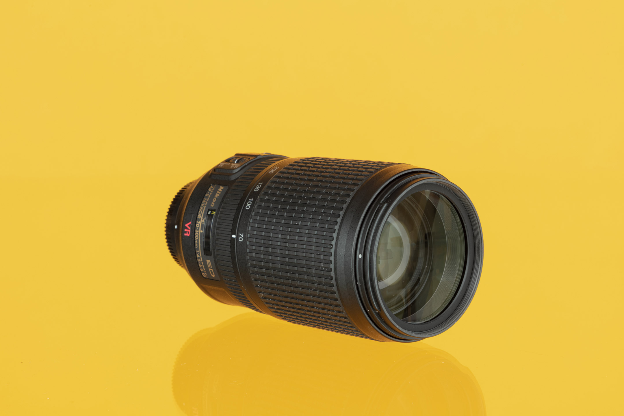 Nikon AF 70-300mm f/4-5.6 G against a yellow background