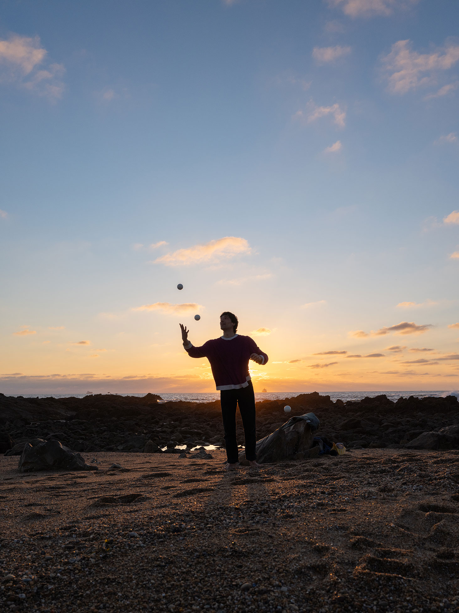 Silhouette of a juggler at sunset. Shot on the Fujifilm GFX100RF by Amy Moore.