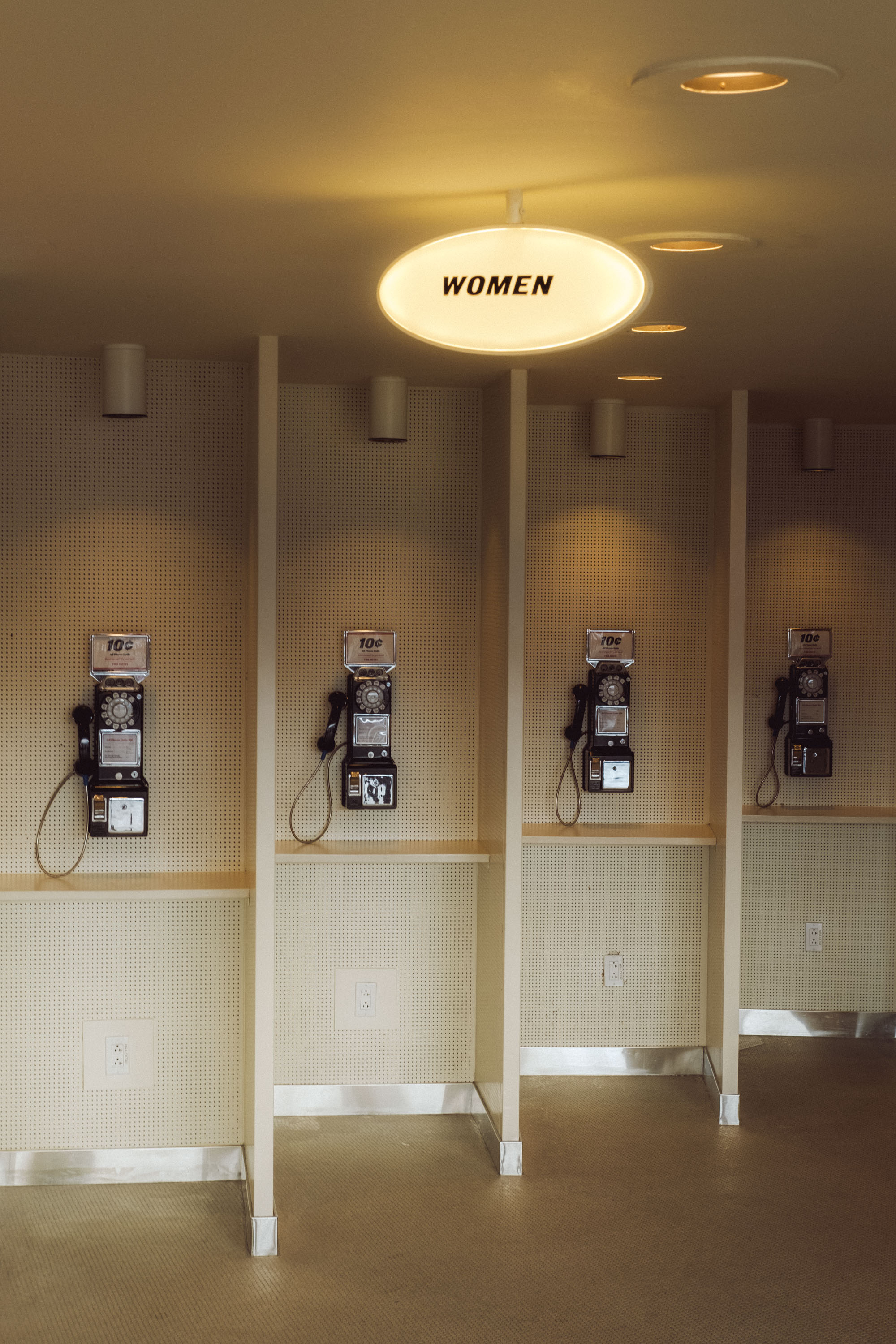 A retro-looking telephone booth with a ‘Women’ sign is above it at the TWA Airport in New York. Shot on the X-Pro 3 by Ian Howorth.