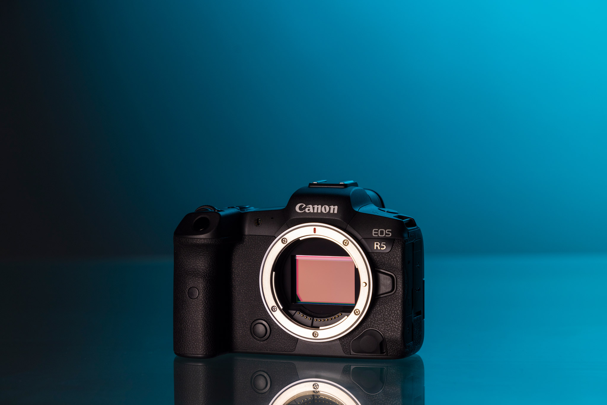 Canon EOS R5 on a blue background.