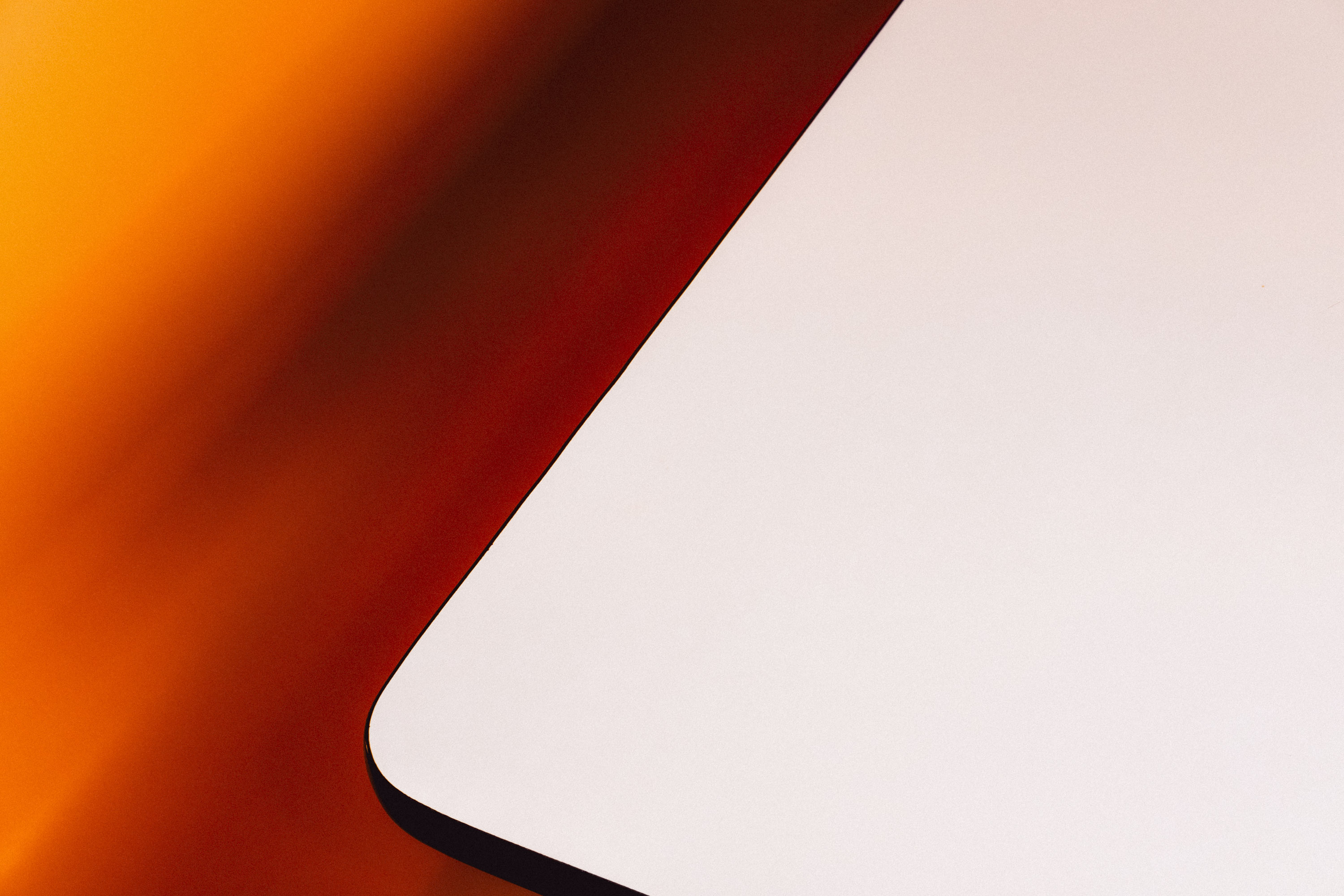 A white Formica table with a burnt orange and brown background. Shot on the X-Pro 3 by Ian Howorth.