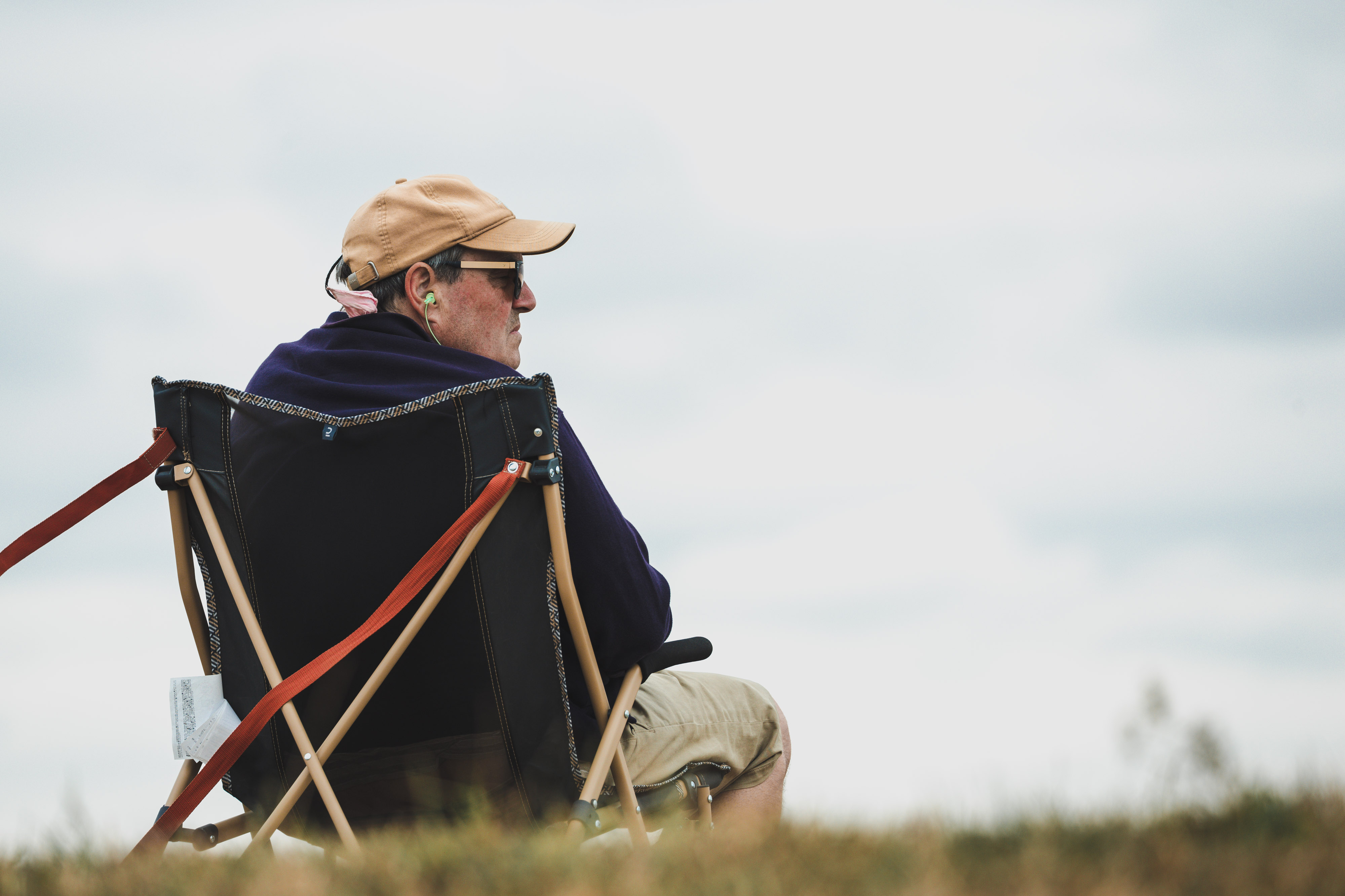 A person sitting on a chair watching racing