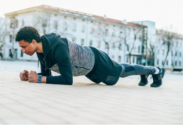 sporty-man-doing-plank-picture-id1146531564