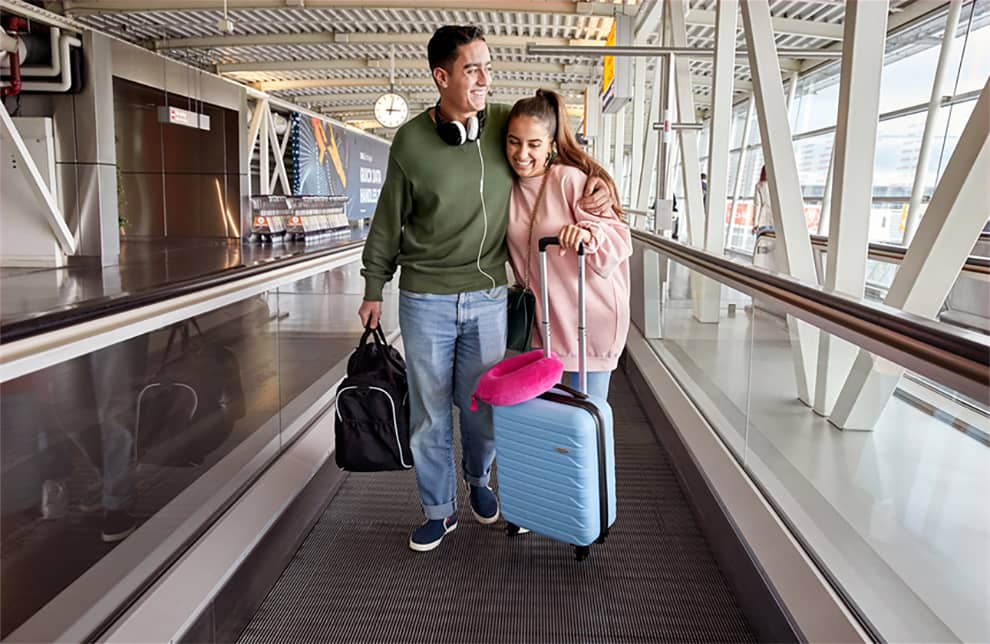 Couple with luggage on the travelator