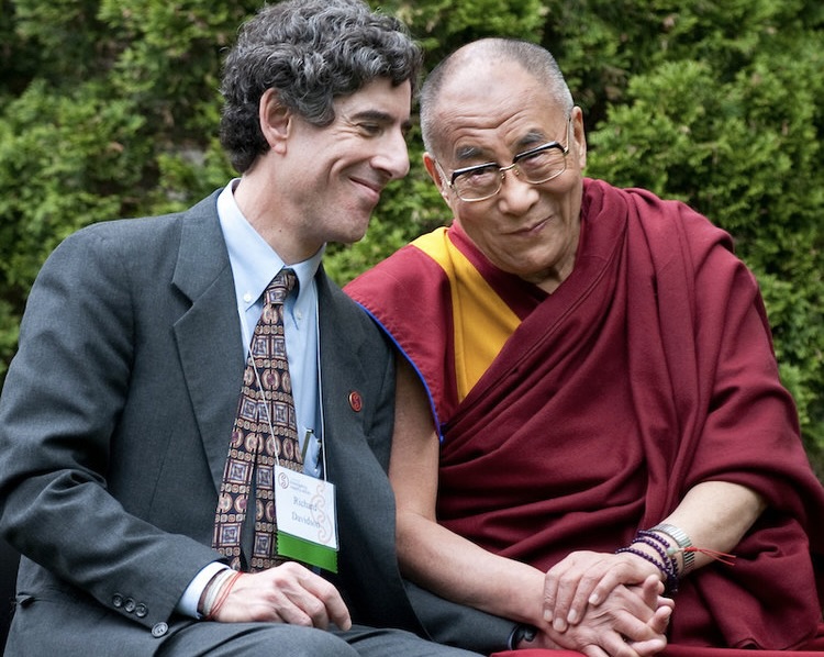 a picture of the Dalia Lama with a group of people