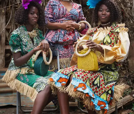 3 women from the City of Joy in outfits made from Vlisco fabric