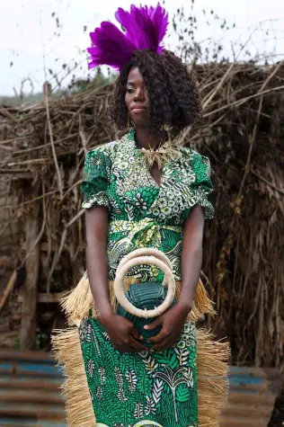 A woman from the City of Joy modeling outfits made from Vlisco fabrics