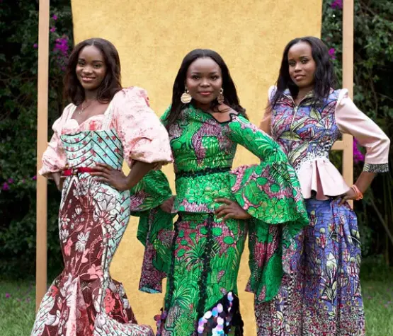 Three African women from the City of Joy modeling outfits made from Vlisco wax fabrics